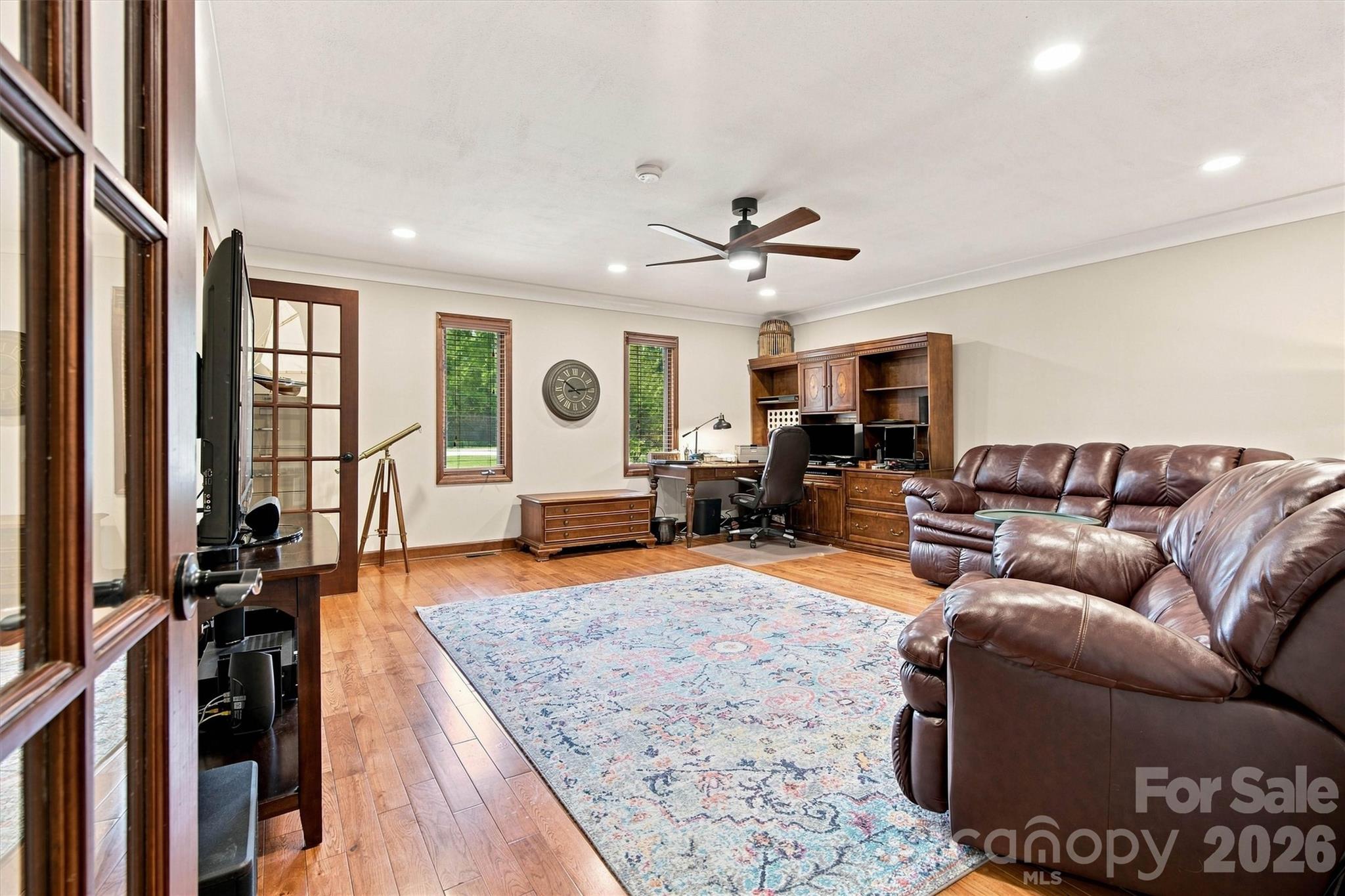 This versatile bonus room features original wood and glass doors, offering dual access from both the mudroom hallway and the family room. With its generous size and flexible layout, this space is perfect for a home office, media room, guest suite, or hobby area—the possibilities are endless! - 3867 Angie Drive, Denver