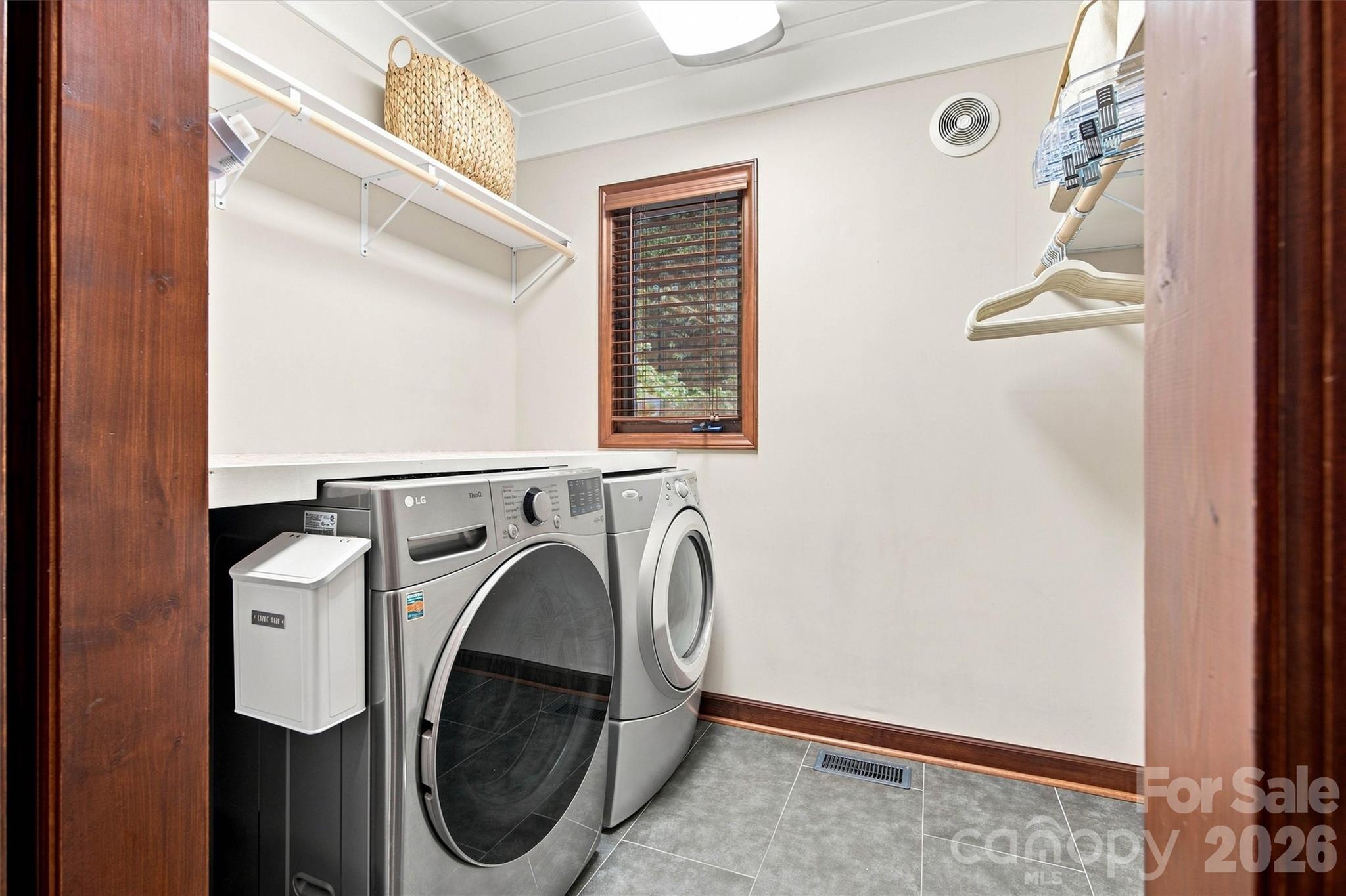 Laundry Room with shelving and hanging rods is spacious. - 3867 Angie Drive, Denver