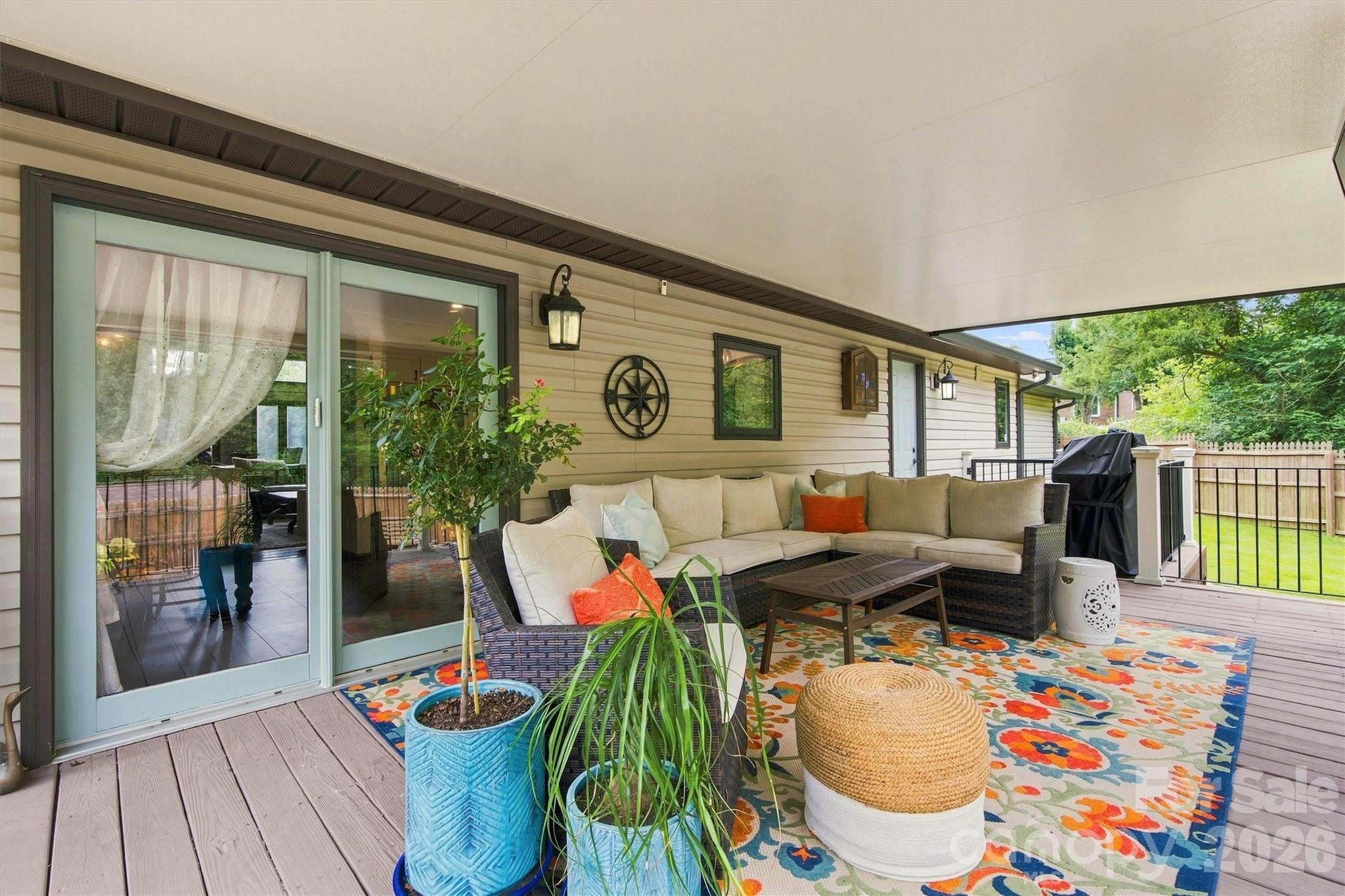 Spacious rear porch provides plenty of room for outdoor furniture and an open grilling deck sits just beyond, near the door to the mudroom bathroom. Easy to pop in for a quick bathroom break without going through the house! - 3867 Angie Drive, Denver