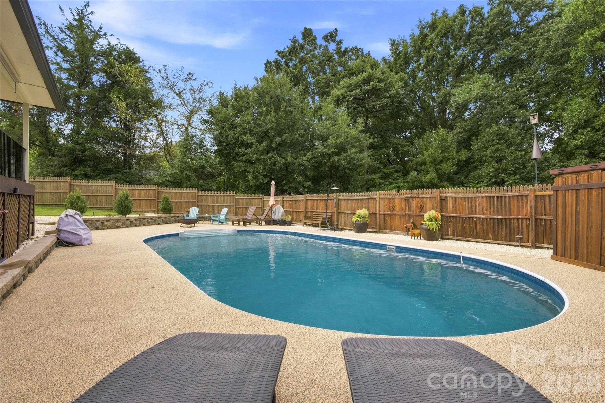 This sparkling pool is the perfect retreat for these hot summer days, featuring a newly installed rubber deck coating that makes poolside lounging more comfortable and enjoyable than ever. - 3867 Angie Drive, Denver