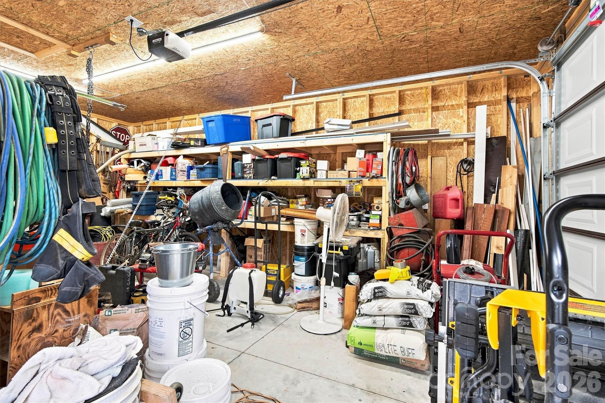 Interior of garage/workshop has a ton of built in storage, concrete floor, 65amp power. - 3867 Angie Drive, Denver