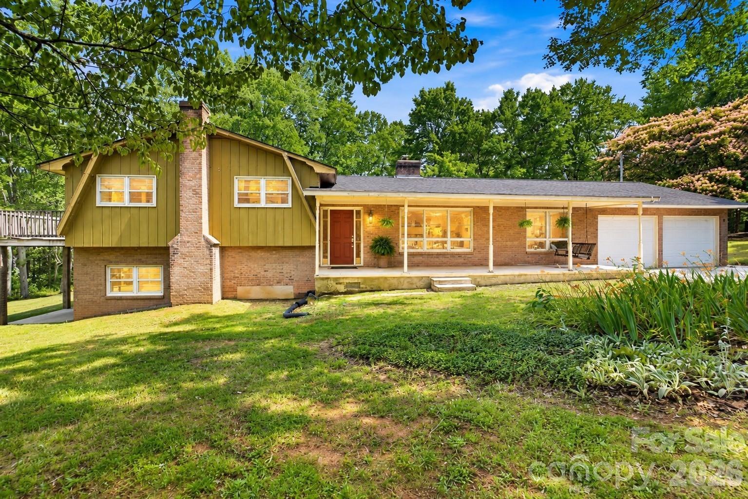 Relax, unwind, and enjoy the view from the front porch of this inviting split-level home. Virtually enhanced twilight image. - 2619 Hopewell Church Road, Sherrills Ford