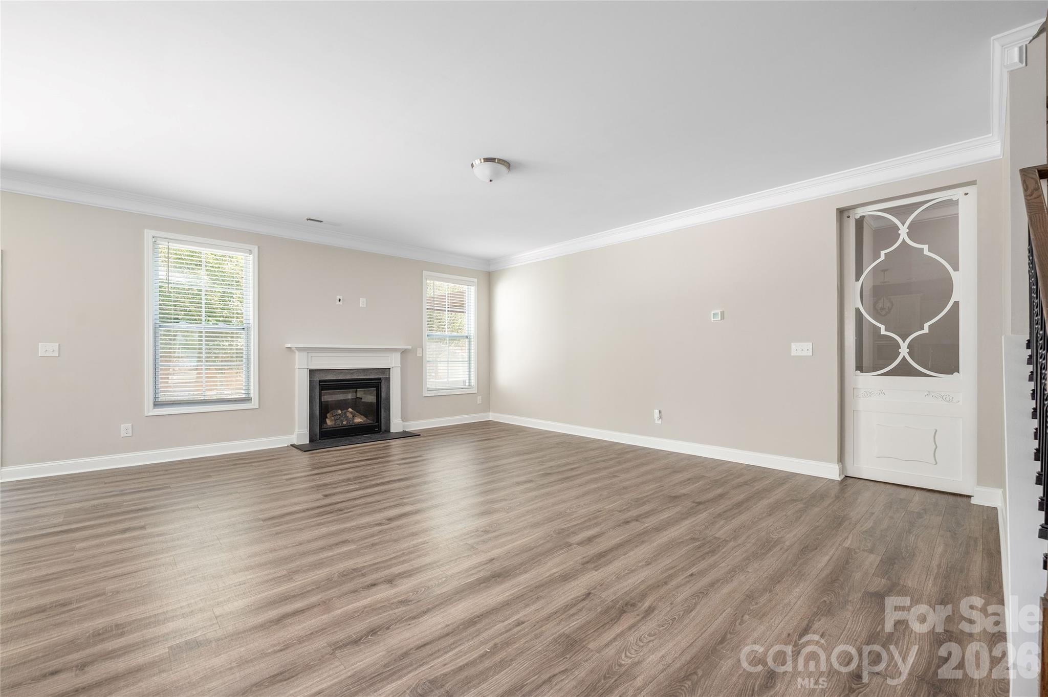 Living room with sliding door to downstairs bedroom closed - 144 Chance Road, Mooresville