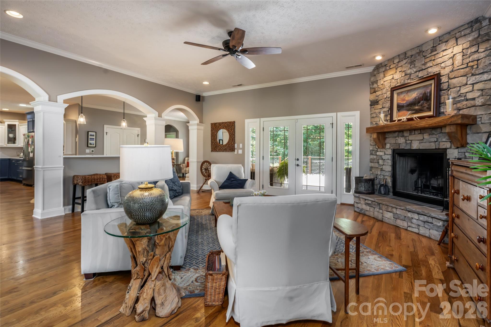 Living room with wood burning fireplace and access to upper deck through covered area - 170 Cape Martin Circle, Hendersonville