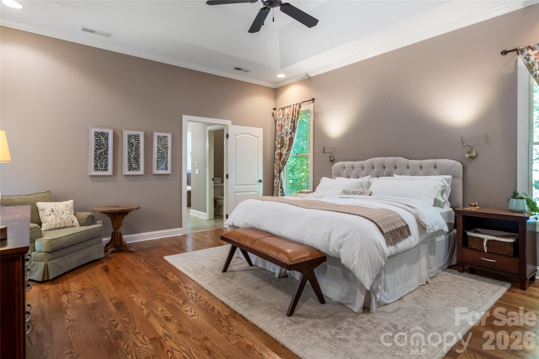 Primary bedroom with two walk in closets, Primary bath, main level, with walk in shower and jet tub, and upper deck access to covered area. - 170 Cape Martin Circle, Hendersonville