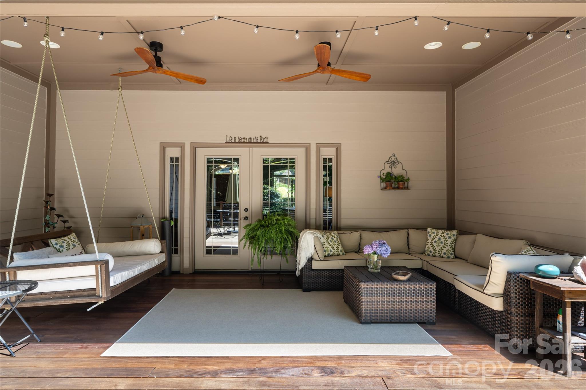 A large, private back porch with Ipe flooring and a hanging porch bed - 170 Cape Martin Circle, Hendersonville
