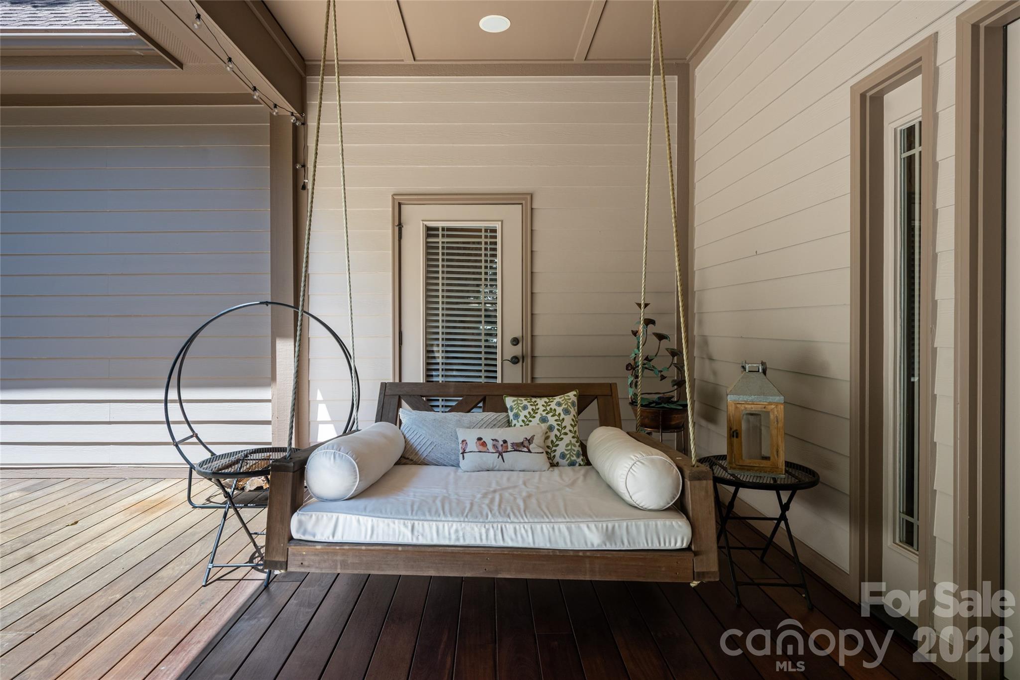 A large, private back porch with Ipe flooring and a hanging porch bed - 170 Cape Martin Circle, Hendersonville
