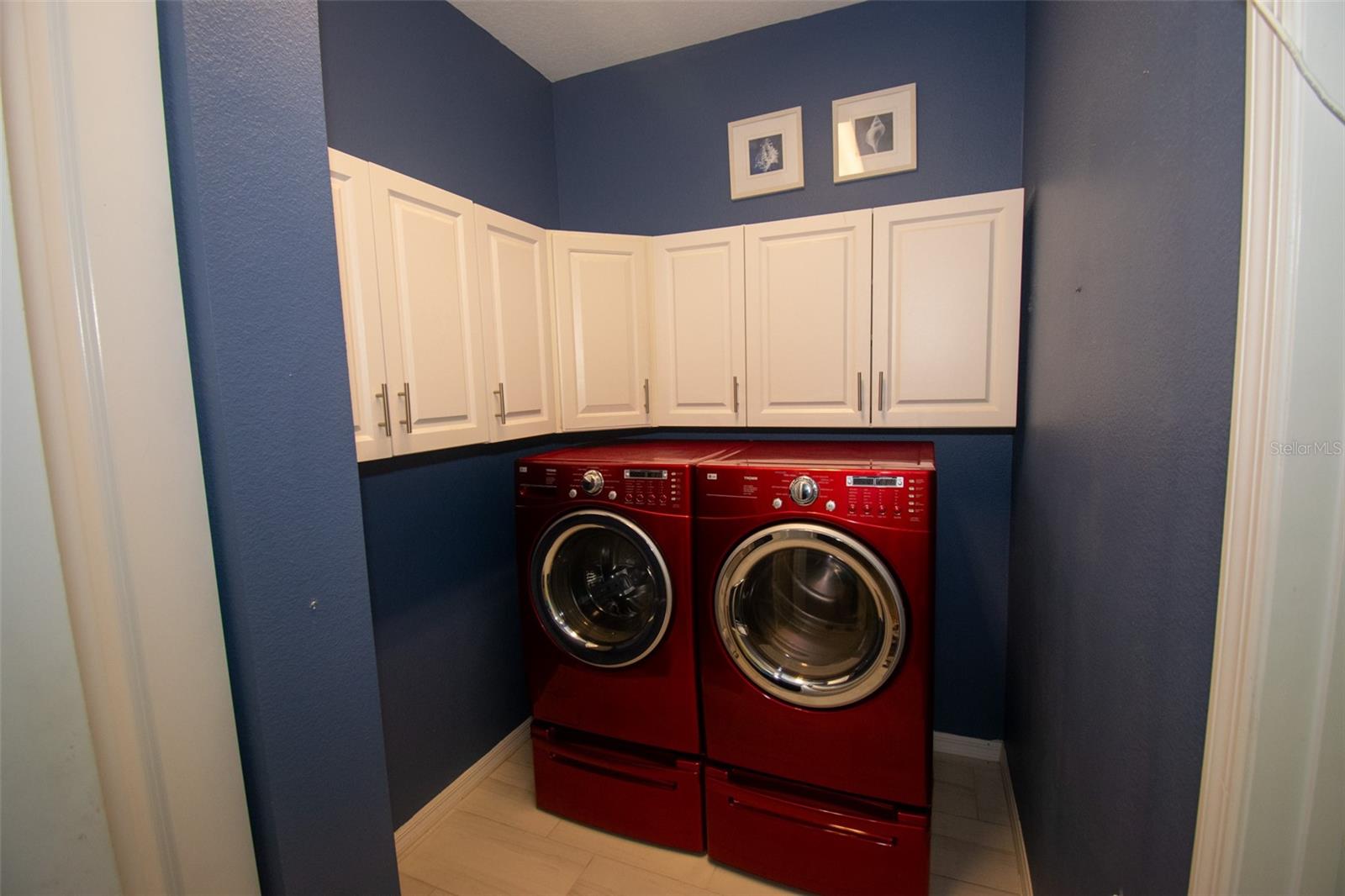 Located near the center of the house is your indoor laundry room. Washer and dryer stay with the home and have selves for detergent storage underneath. - 225 BIRCHWOOD DR, PALM COAST