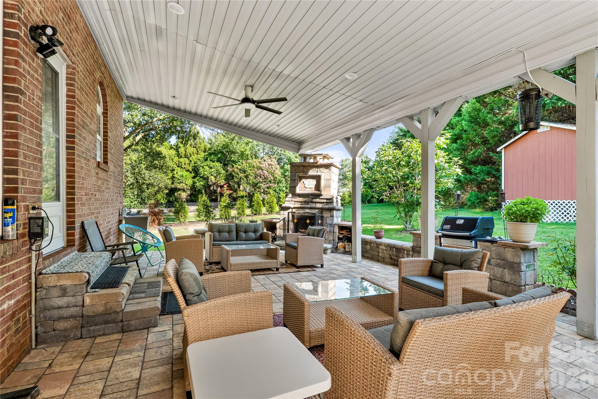 Come relax on the stunning covered patio with a hot tub and outdoor fireplace. - 21717 Shoveller Court, Cornelius