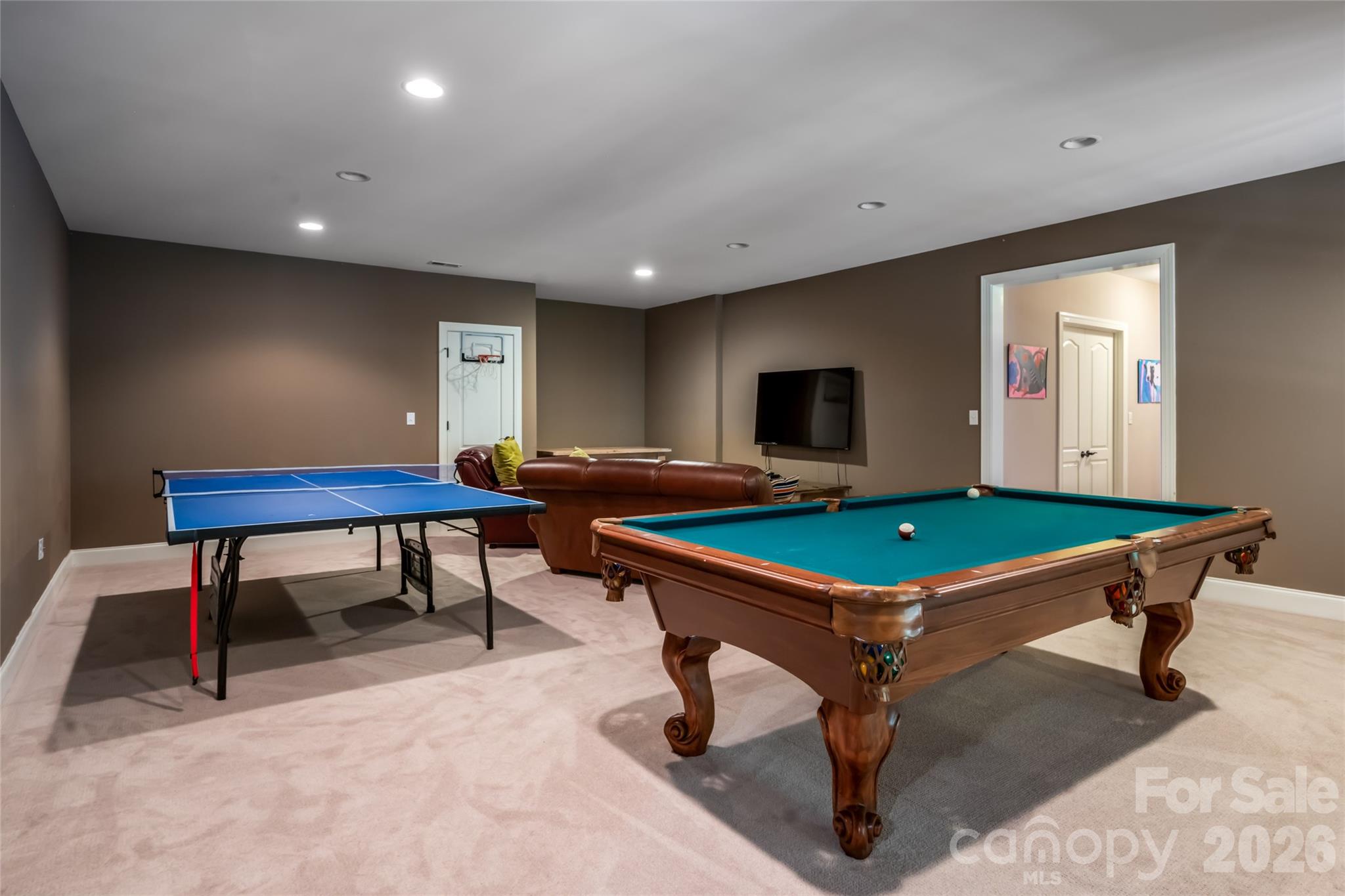 Doubled the size of the house by adding a downstairs that includes two large bedrooms, a full bath with a double sink, craft/video room, rec room, gym and storage - 170 Cape Martin Circle, Hendersonville