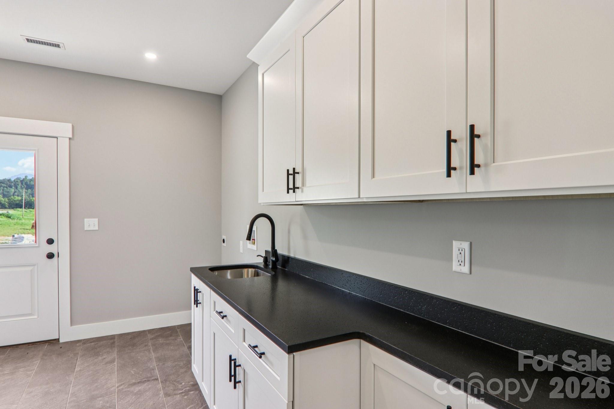 Laundry/Mud room with garage & side door entrance. - 1060 California Creek Road, Mars Hill