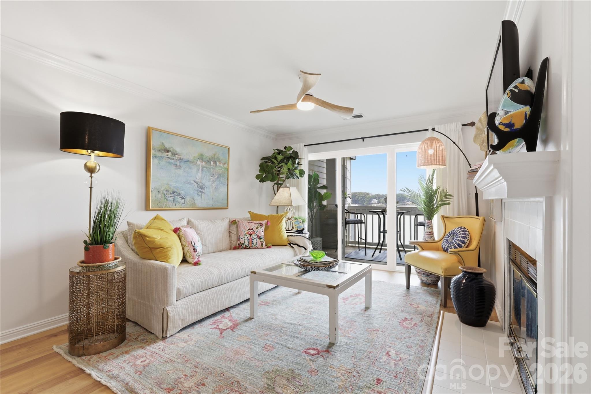 Great room featuring waterfront scenery and a cozy fireplace. - 932 Southwest Drive, Davidson