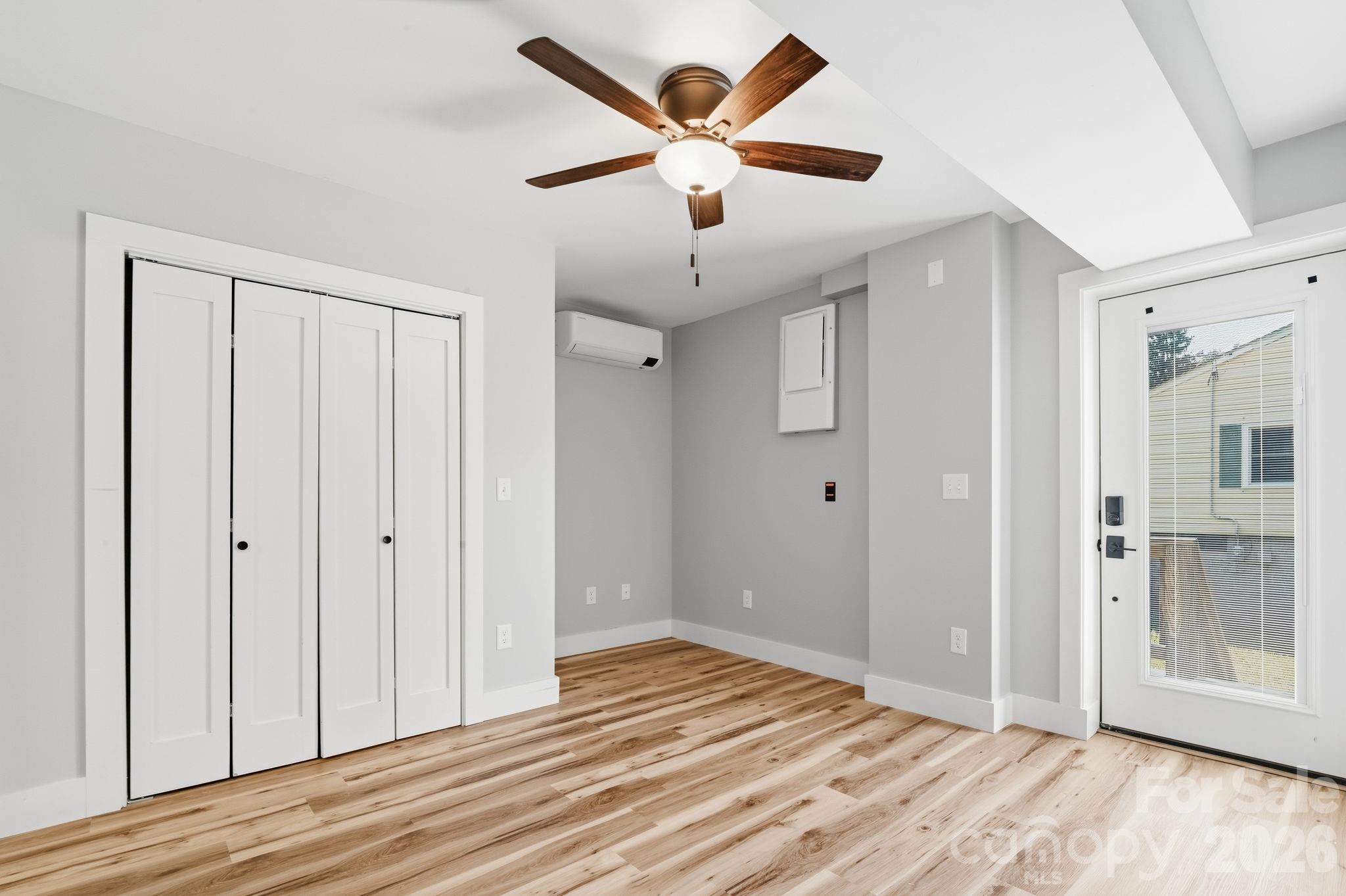 Primary bedroom with door to private deck - 77 Trotter Place, Asheville