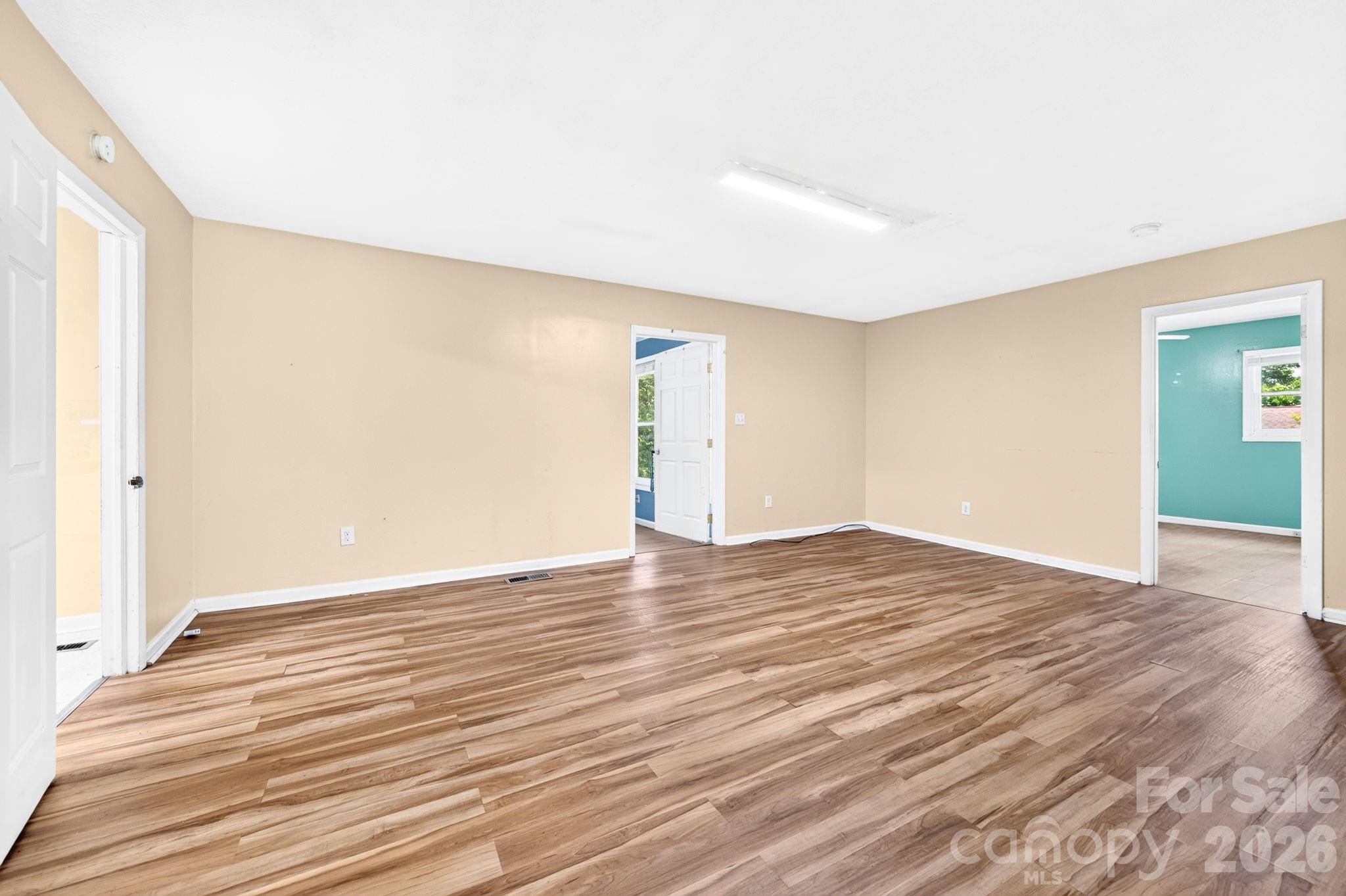 View of dining area from hallway. Bedroom 2 on right and bedroom 3 in middle and kitchen to left - 483 Caribou Road, Asheville