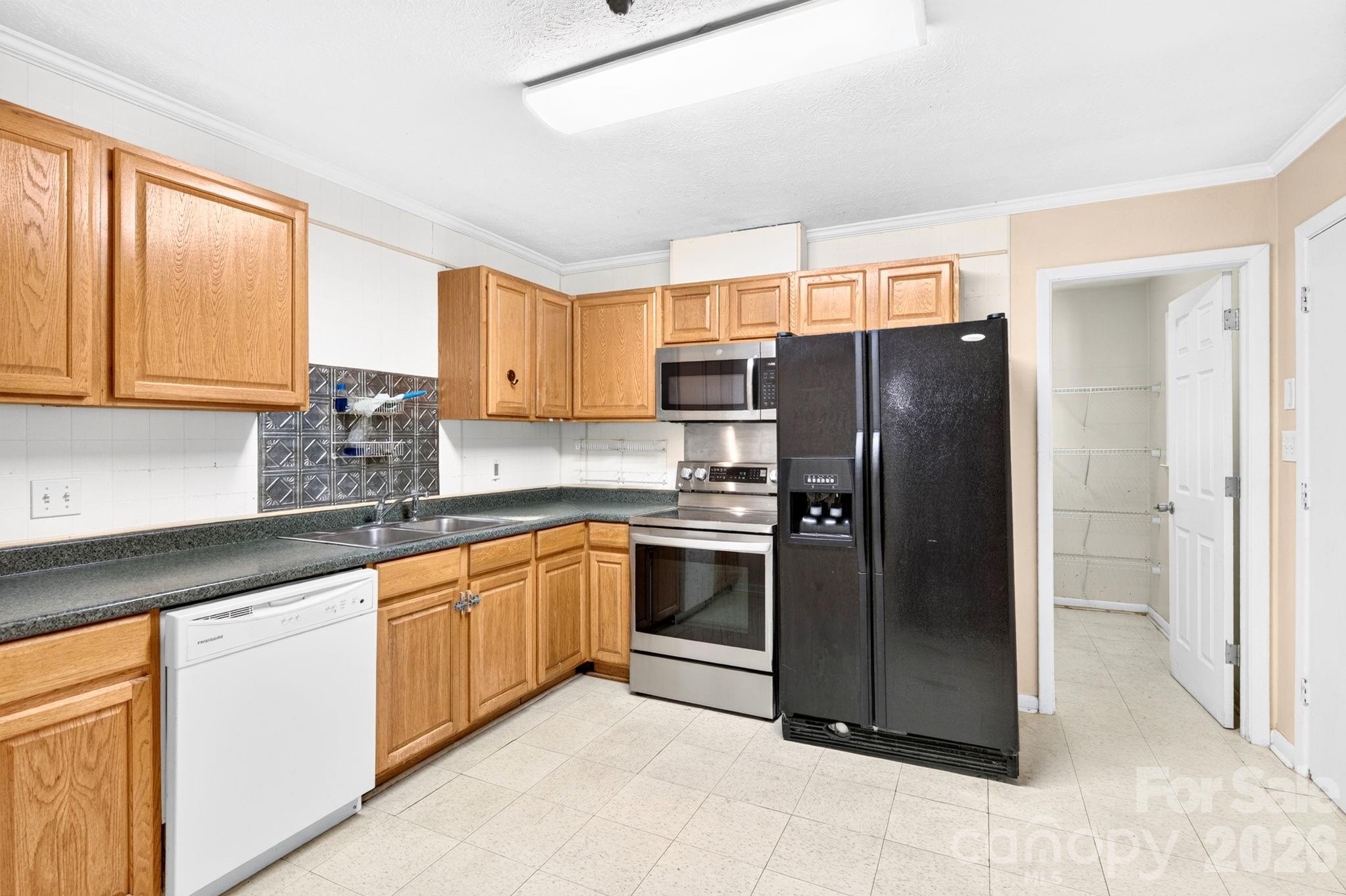 Kitchen with pantry. Mudroom door to the right - 483 Caribou Road, Asheville
