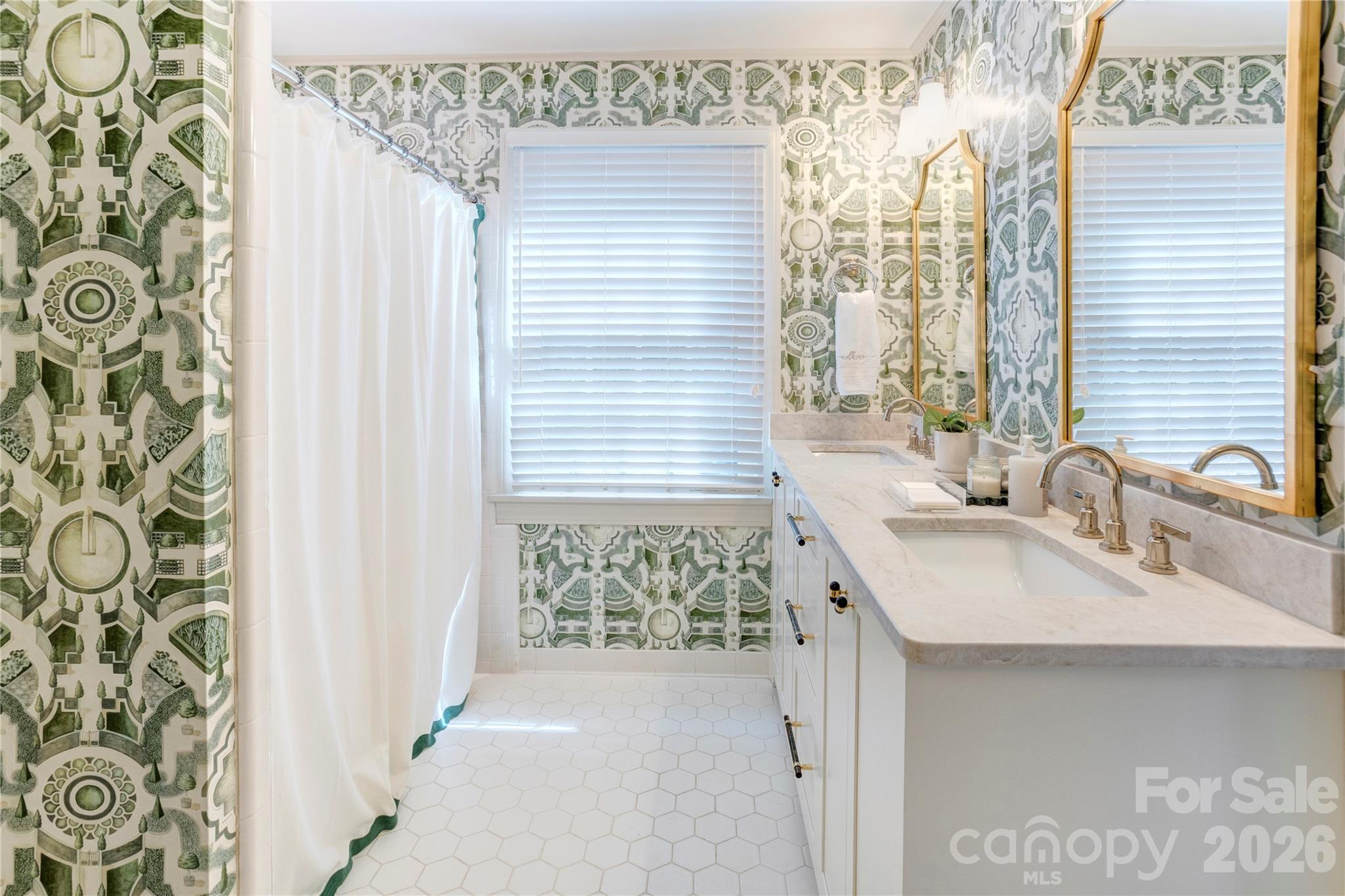 The downstairs hall bath features a custom vanity, Taj Mahal Quartzite and designer wallpaper. - 215 Bethel Drive, Salisbury