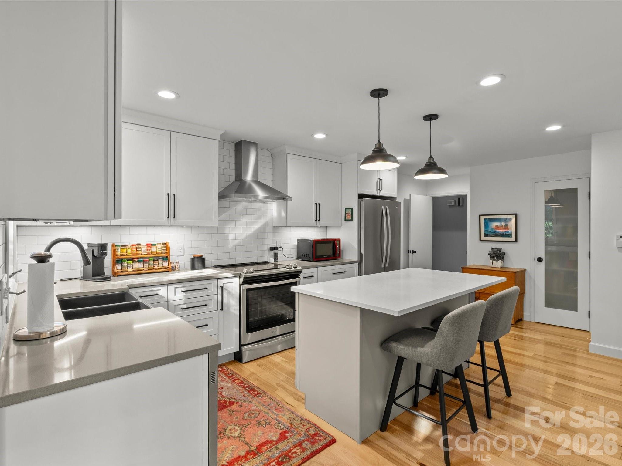 The bright and modern kitchen ensures meal prep is never a chore - 110 Aurora Drive, Asheville