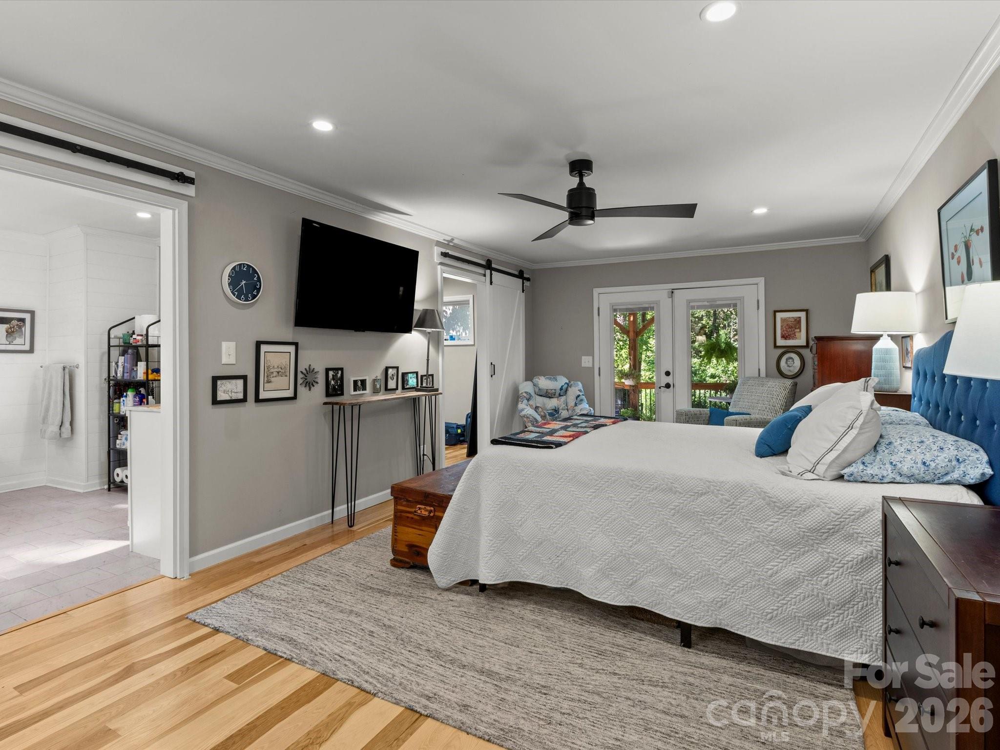 Crown molding and hardwood floors accent the primary suite - 110 Aurora Drive, Asheville