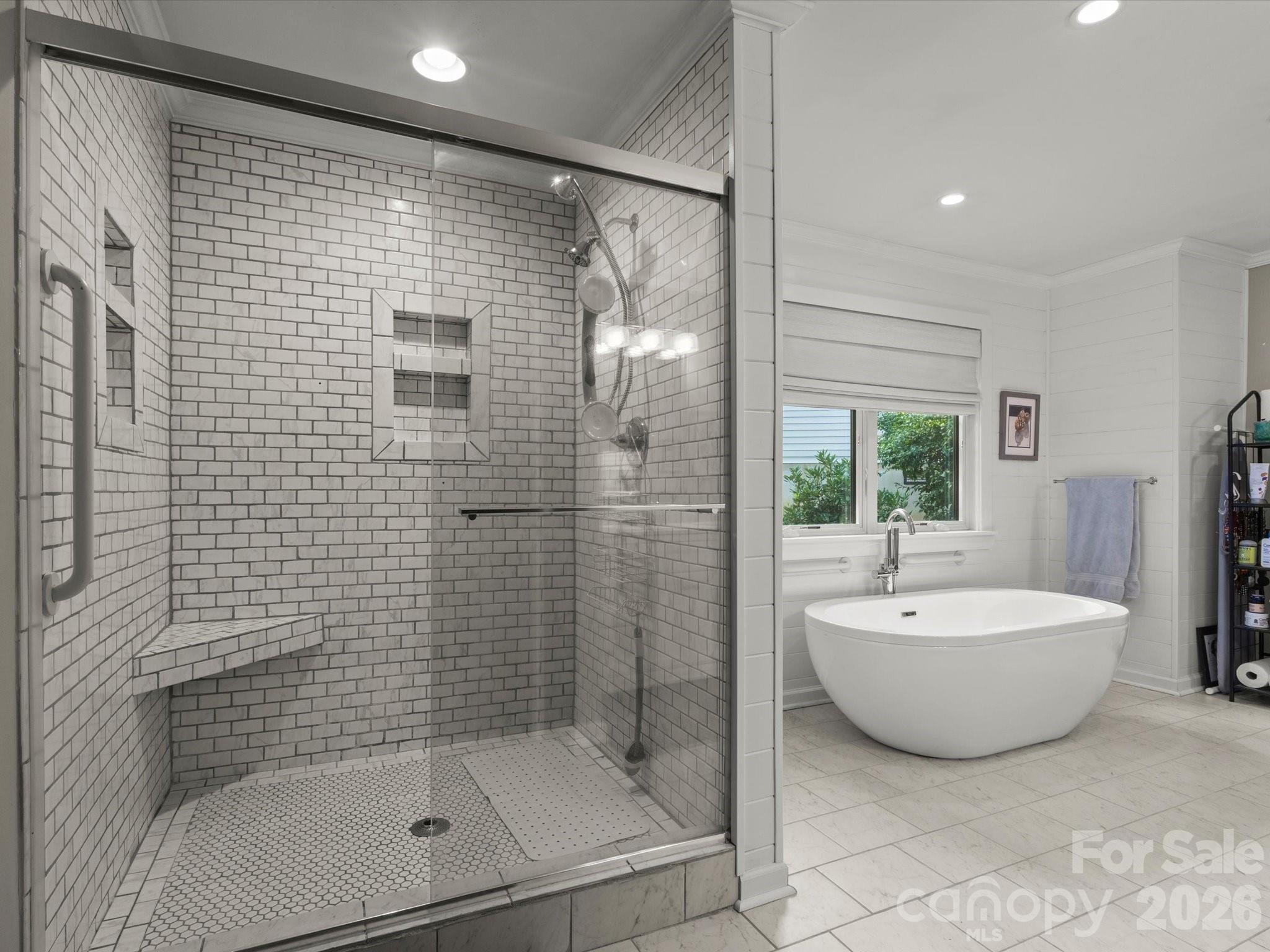 Floor-to-ceiling tiled shower with niches and corner bench in the en suite bathroom - 110 Aurora Drive, Asheville