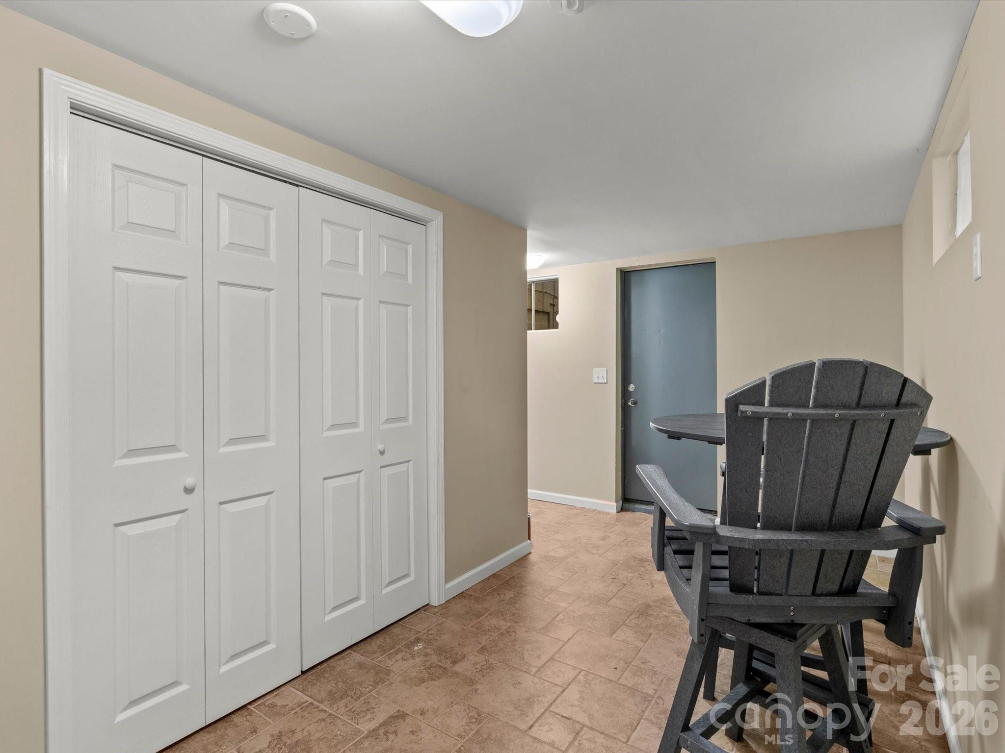 Downstairs, a large lower level provides storage, guest space, or rental income potential - 110 Aurora Drive, Asheville