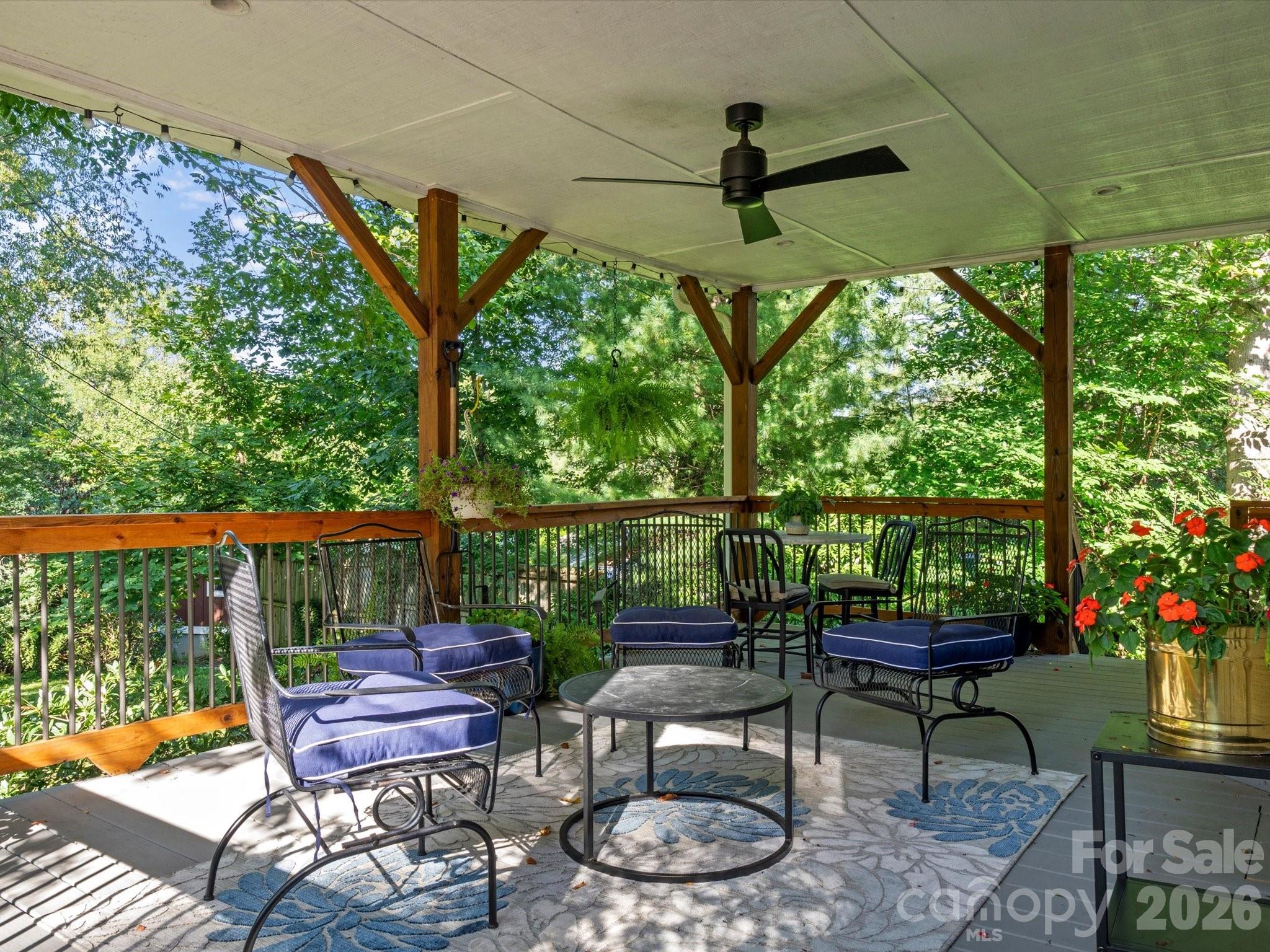 Enjoy morning coffee or evening drinks on the covered back deck - 110 Aurora Drive, Asheville