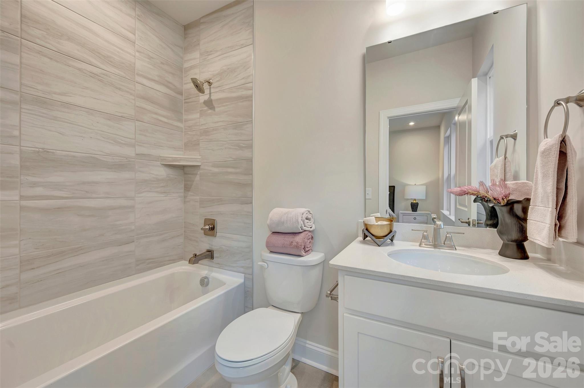 Secondary bathroom with tiled walls above the tub - 309 Old Town Village Road, Waxhaw