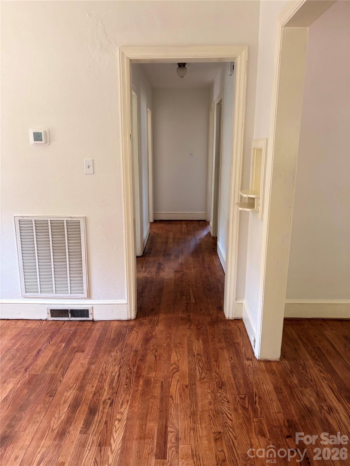 Hallway to sleeping quarters with newly refinished wood flooring - 725 5th Avenue SW, Hickory
