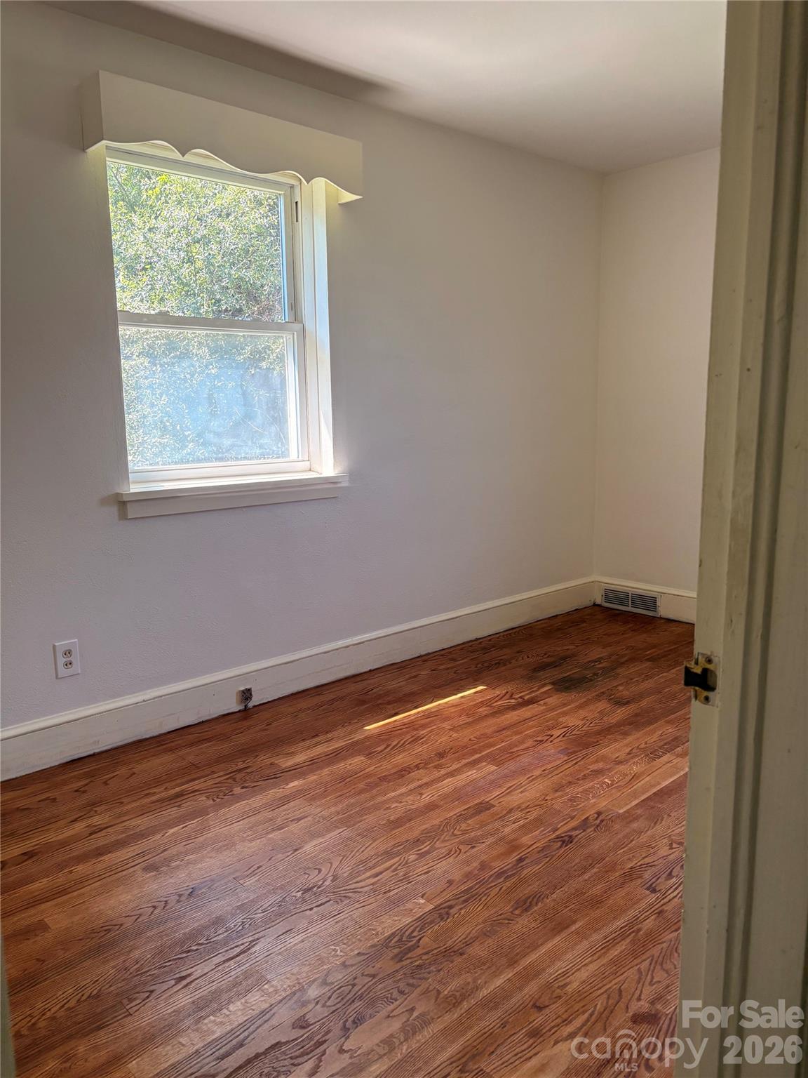 Bedroom with newly refinished wood flooring - 725 5th Avenue SW, Hickory