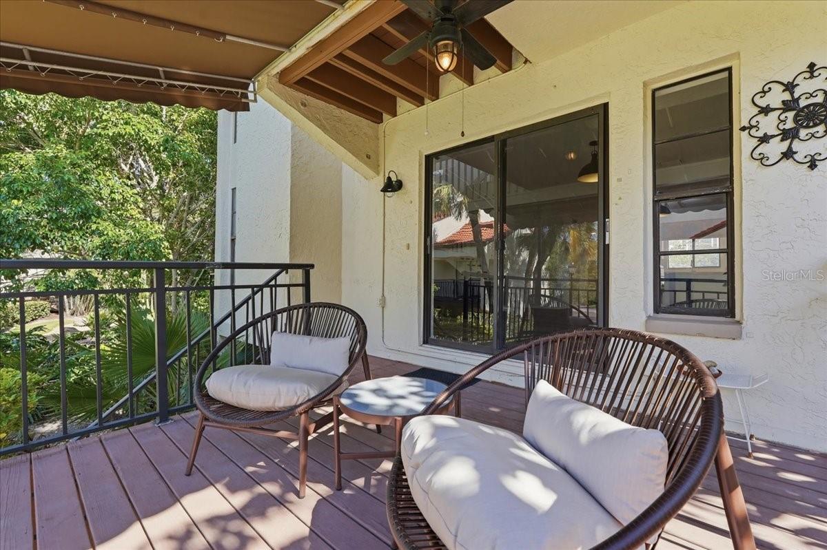 Direct Exterior Access: Features a private stairway leading straight from the balcony down to the ground level, offering excellent convenience and dual-entry functionality with scenic courtyard views. - 240 WINDWARD PSGE #702, CLEARWATER