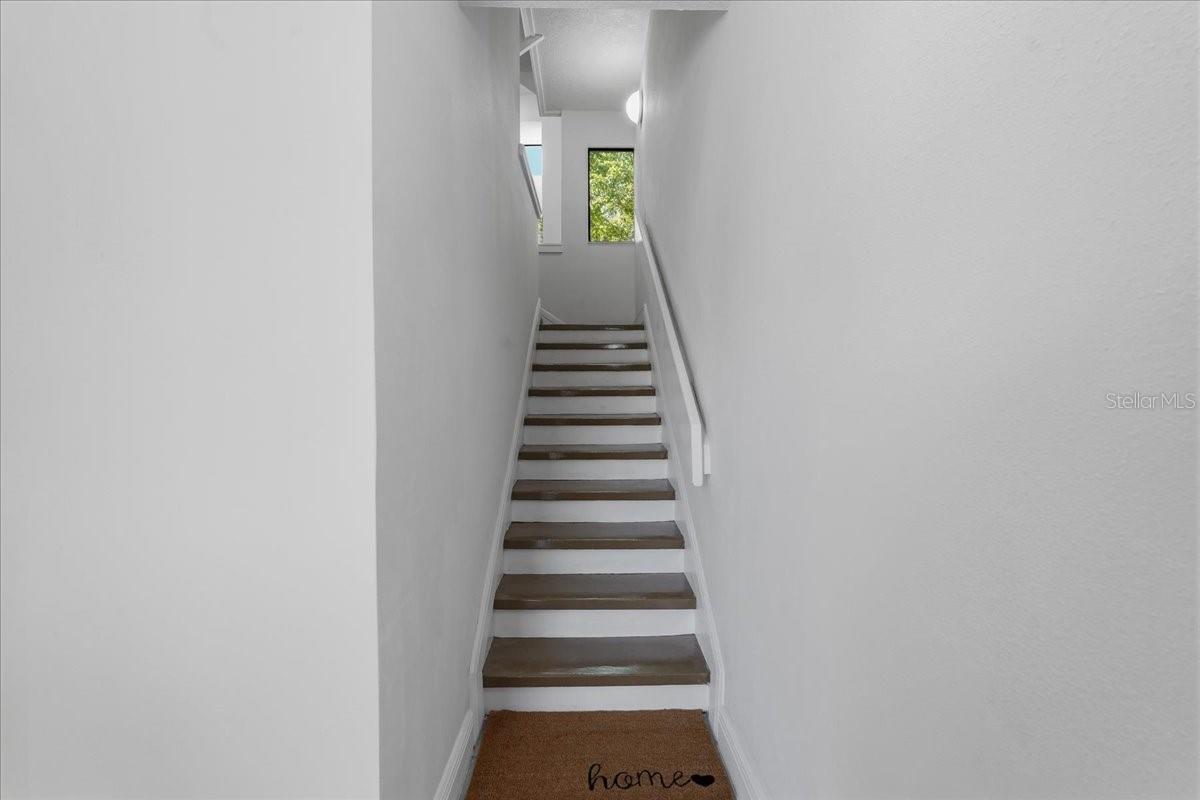 Stairway to the main living area - 240 WINDWARD PSGE #702, CLEARWATER