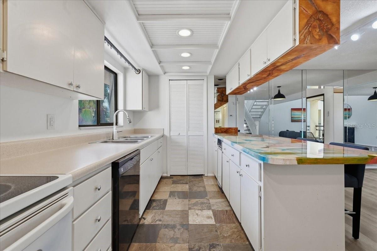 This efficient galley layout maximizes workflow with abundant counter space and seamless movement. - 240 WINDWARD PSGE #702, CLEARWATER