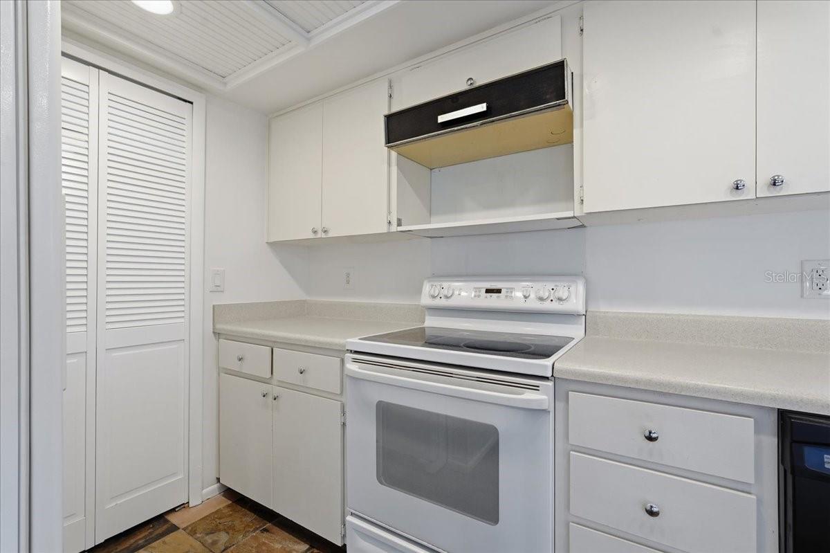 Ergonomic Culinary Layout: Optimized workspace featuring a perfectly positioned range and refrigerator configuration to maximize floor space and cooking efficiency - 240 WINDWARD PSGE #702, CLEARWATER