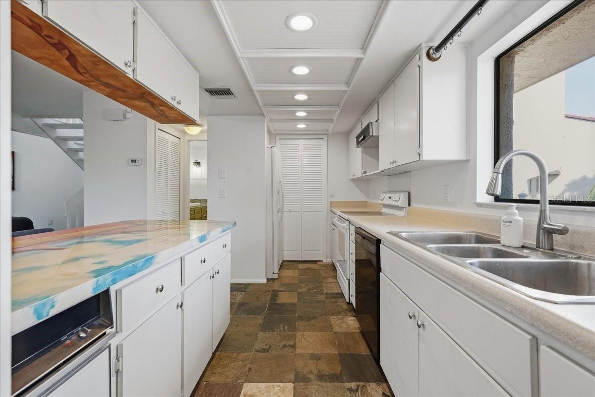 Bright & Airy Feel: Enhanced by overhead recessed lighting, a modern tray ceiling, and a large window overlooking paradise - 240 WINDWARD PSGE #702, CLEARWATER