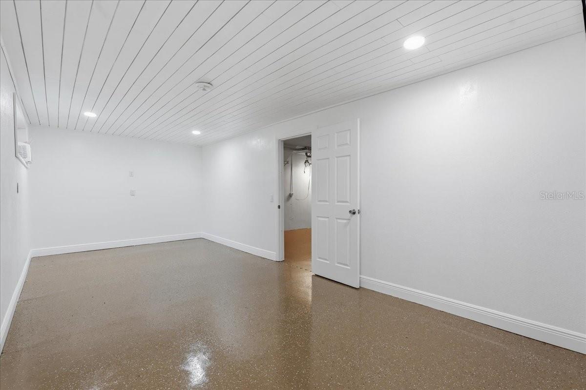 The lower level Bonus Space adds even more versatility with a storage/workshop area and separately air-conditioned “man cave,” ideal for a home office, gym, hobby room or private retreat - 240 WINDWARD PSGE #702, CLEARWATER