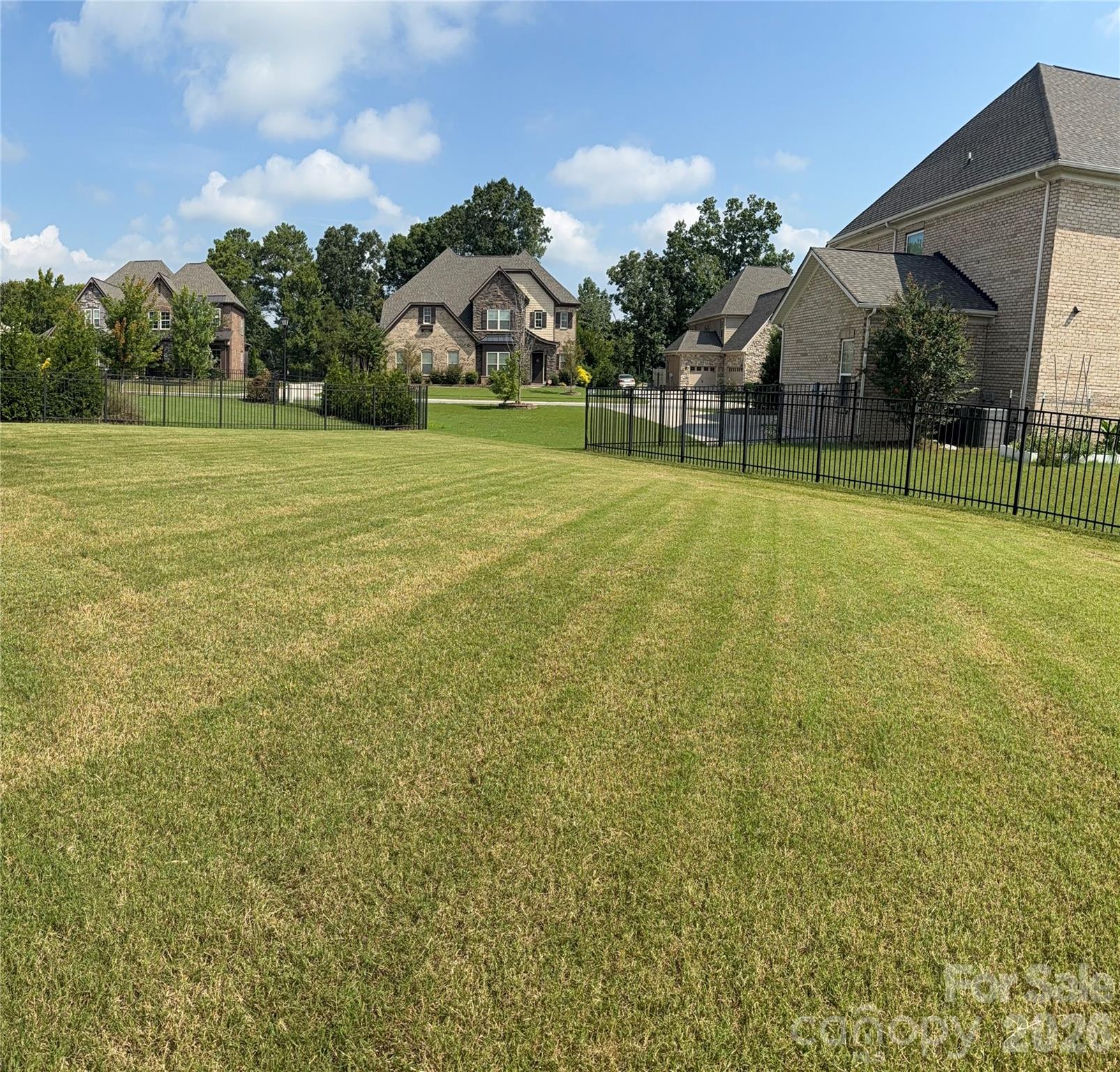 Spacious Backyard (alternate view) w/3 sided wrought iron fencing. Owner previously had invisible fencing where the open spacing is located. - 8465 Blume Parkway, Harrisburg
