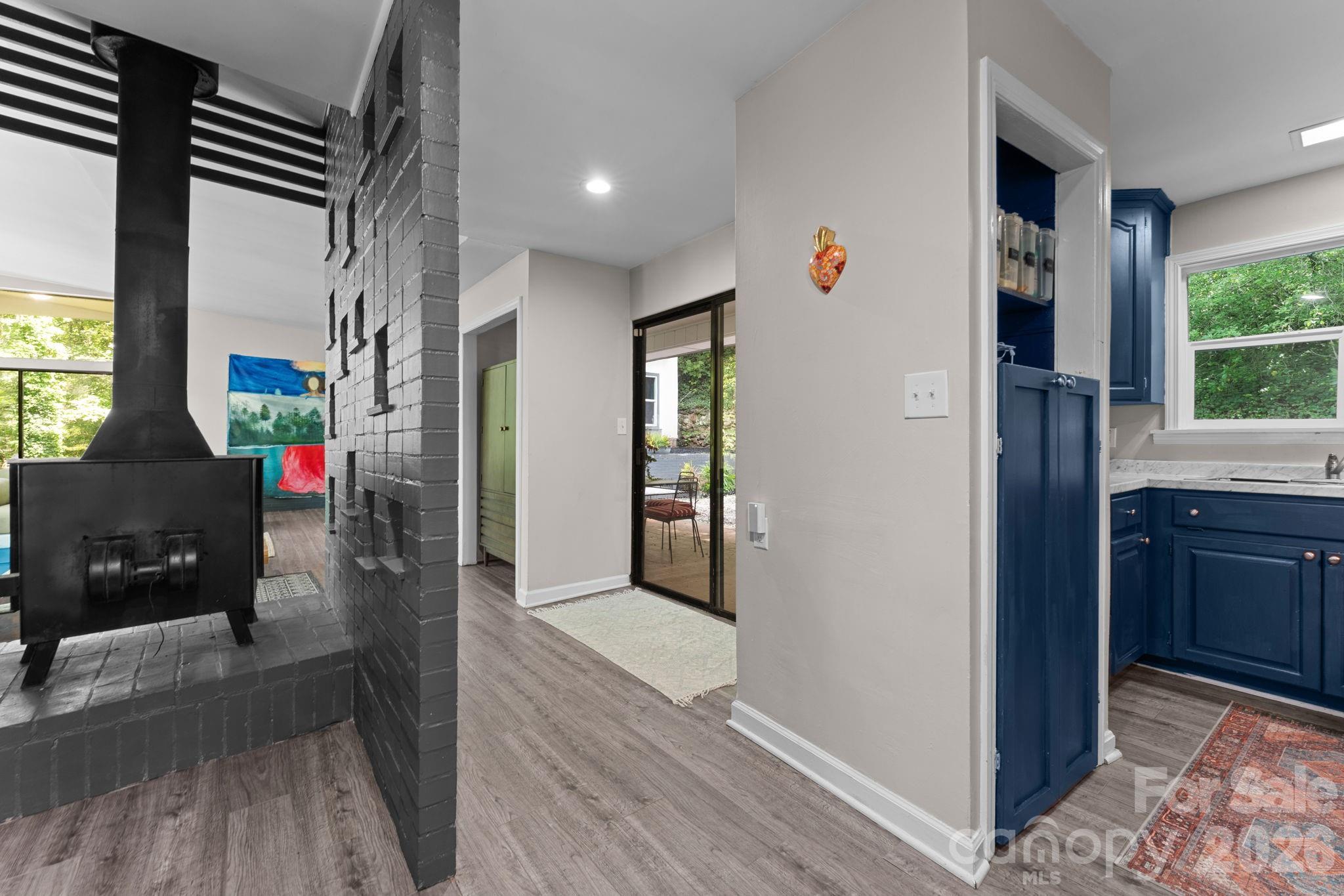 Great Room, Wood Stove, Slider to Back Patio Slider & Kitchen to the right - 103 Riverwood Drive, Sylva