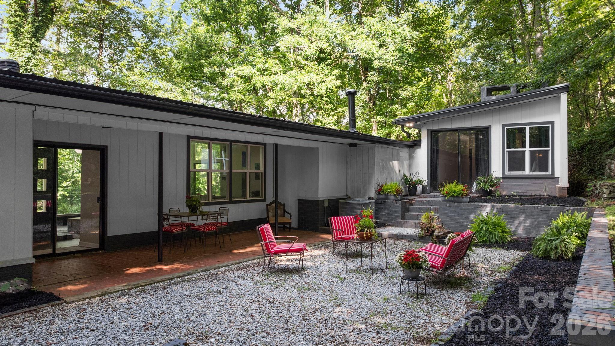 Courtyard Patio, Covered Patio & Entrance to Primary Bedroom - 103 Riverwood Drive, Sylva