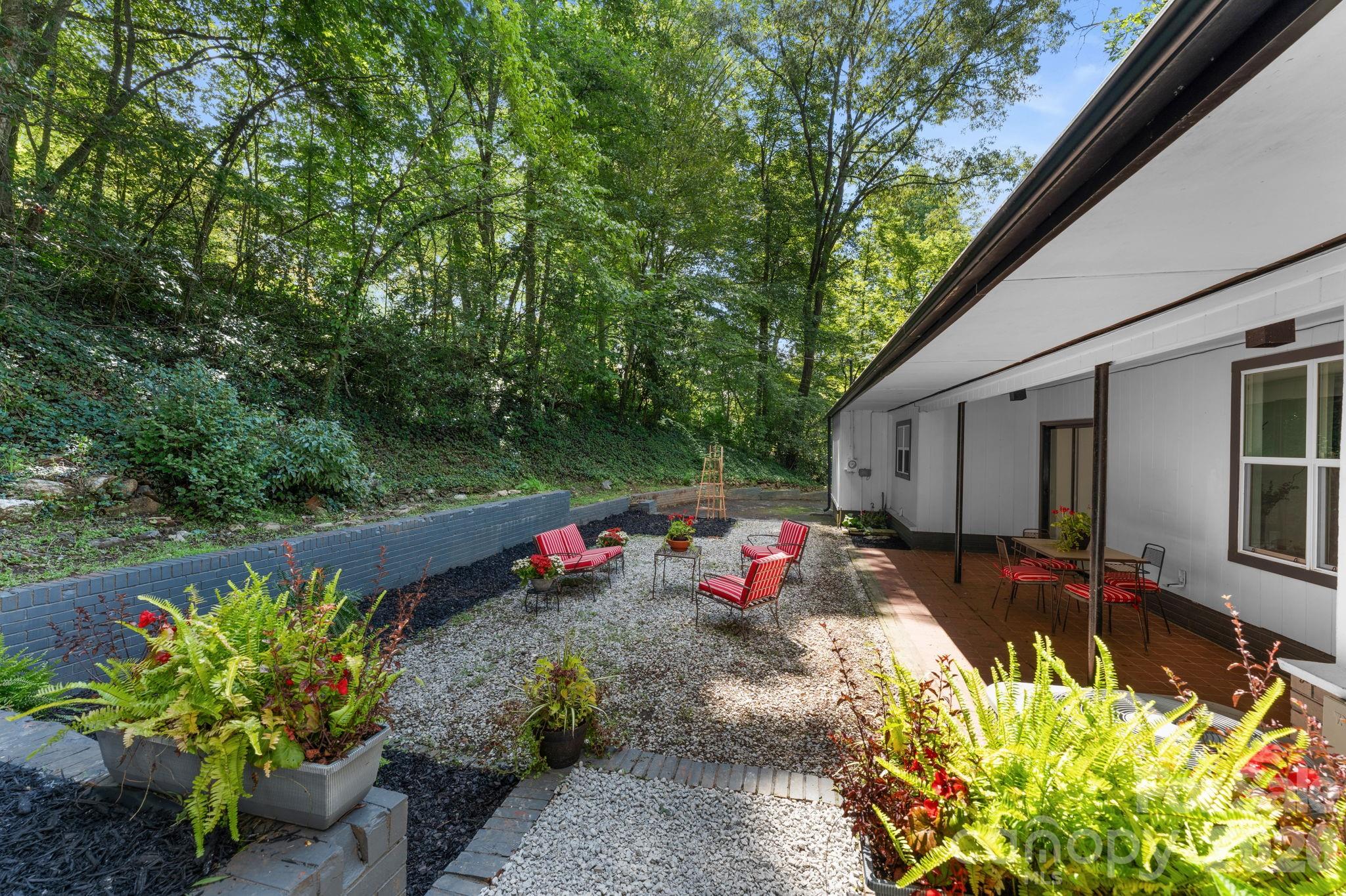 View of Back Courtyard & Covered Patio from Primary Bedroom - 103 Riverwood Drive, Sylva