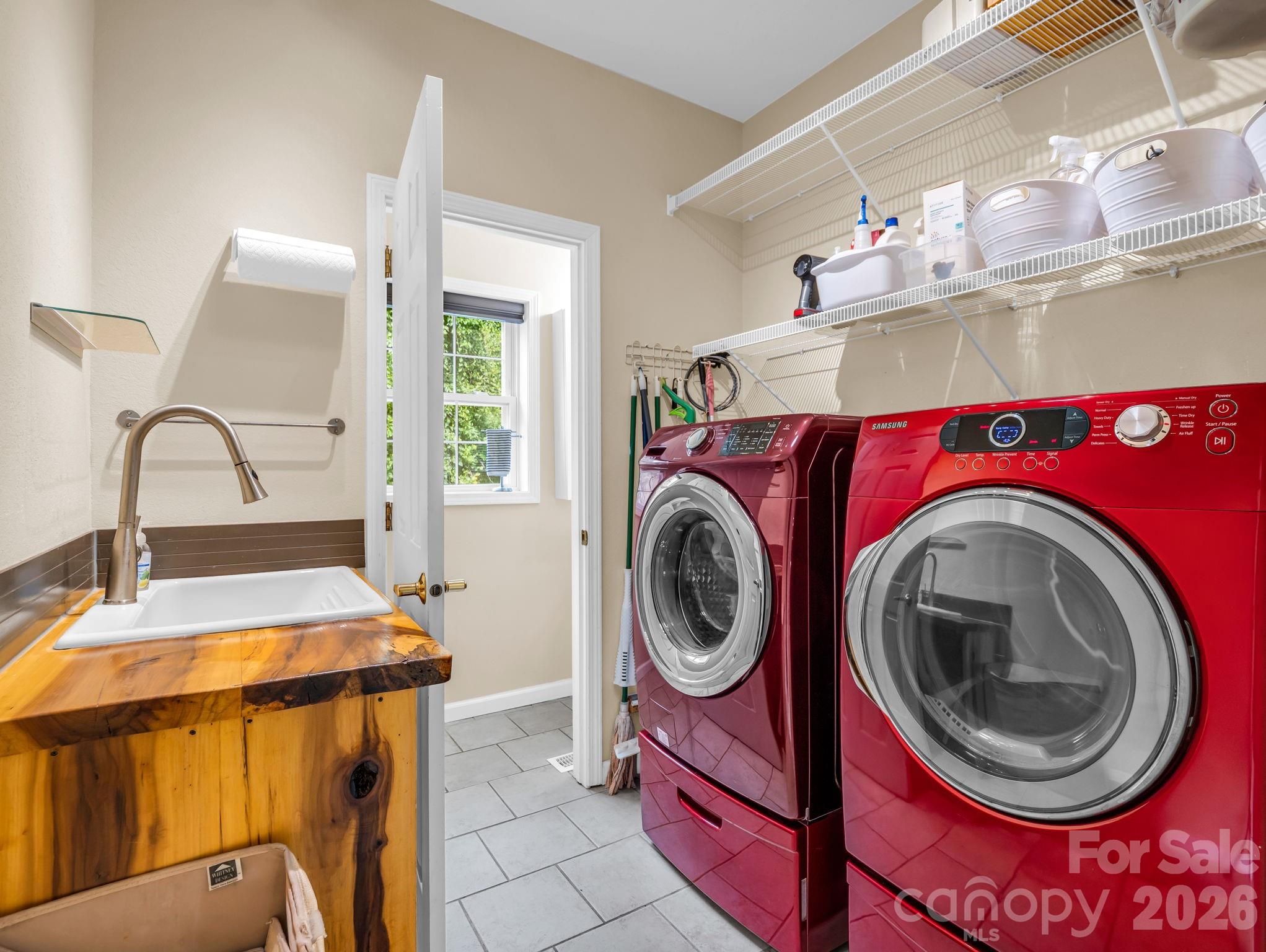 Laundry and mud room along with a half bath - 136 Limousine Lane, Pisgah Forest