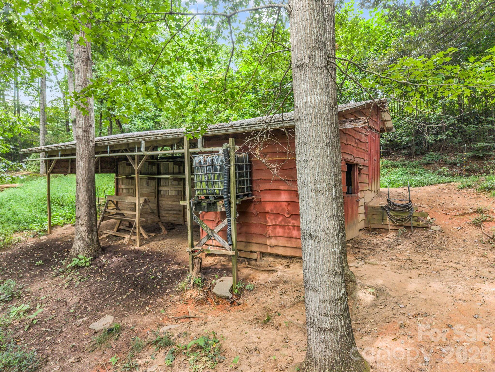 Rainwater catchment! Gutters run into the tote to provide water to the goats. Has a filter,heater,and spigot - 136 Limousine Lane, Pisgah Forest
