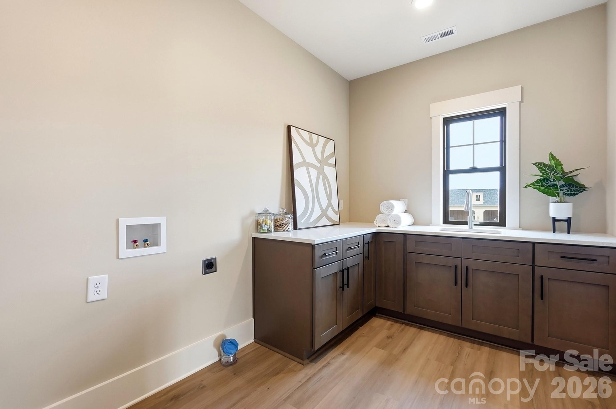 Oversized laundry with custom cabinetry. - 1249 Stonegate Drive, Salisbury