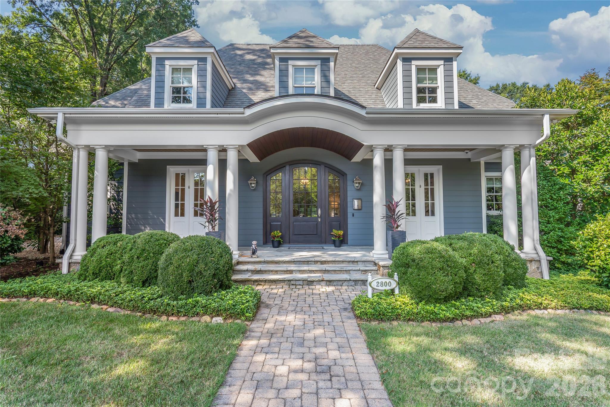 There is more than meets the eye behind this elegant and welcoming front porch. - 2800 Wintergreen Drive, Charlotte
