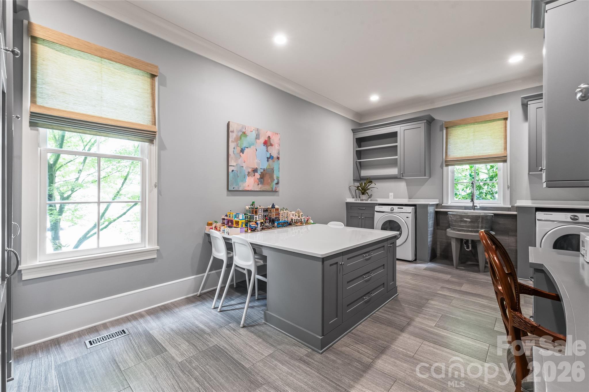 A room for everything. The resource room has storage, workstation, laundry and large center island - 2800 Wintergreen Drive, Charlotte