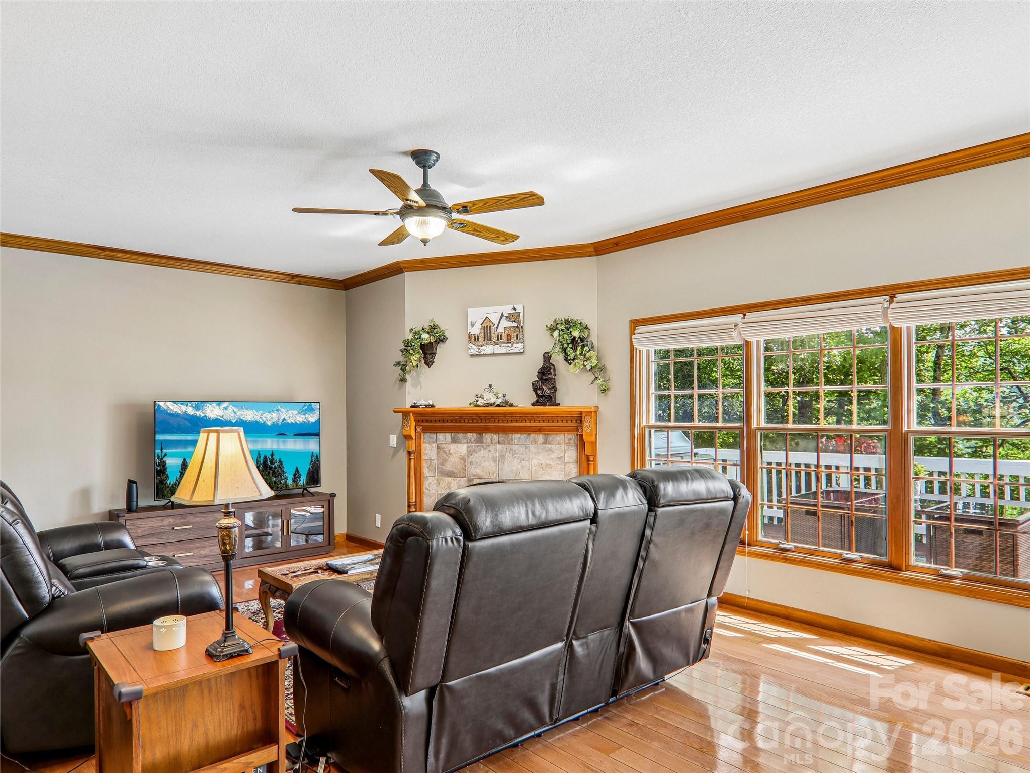Living room, crown molding, ceiling fan for extra comfort. Hardwood flooring throughout main living spaces on the main level. - 16 Hobe Crest, Hendersonville