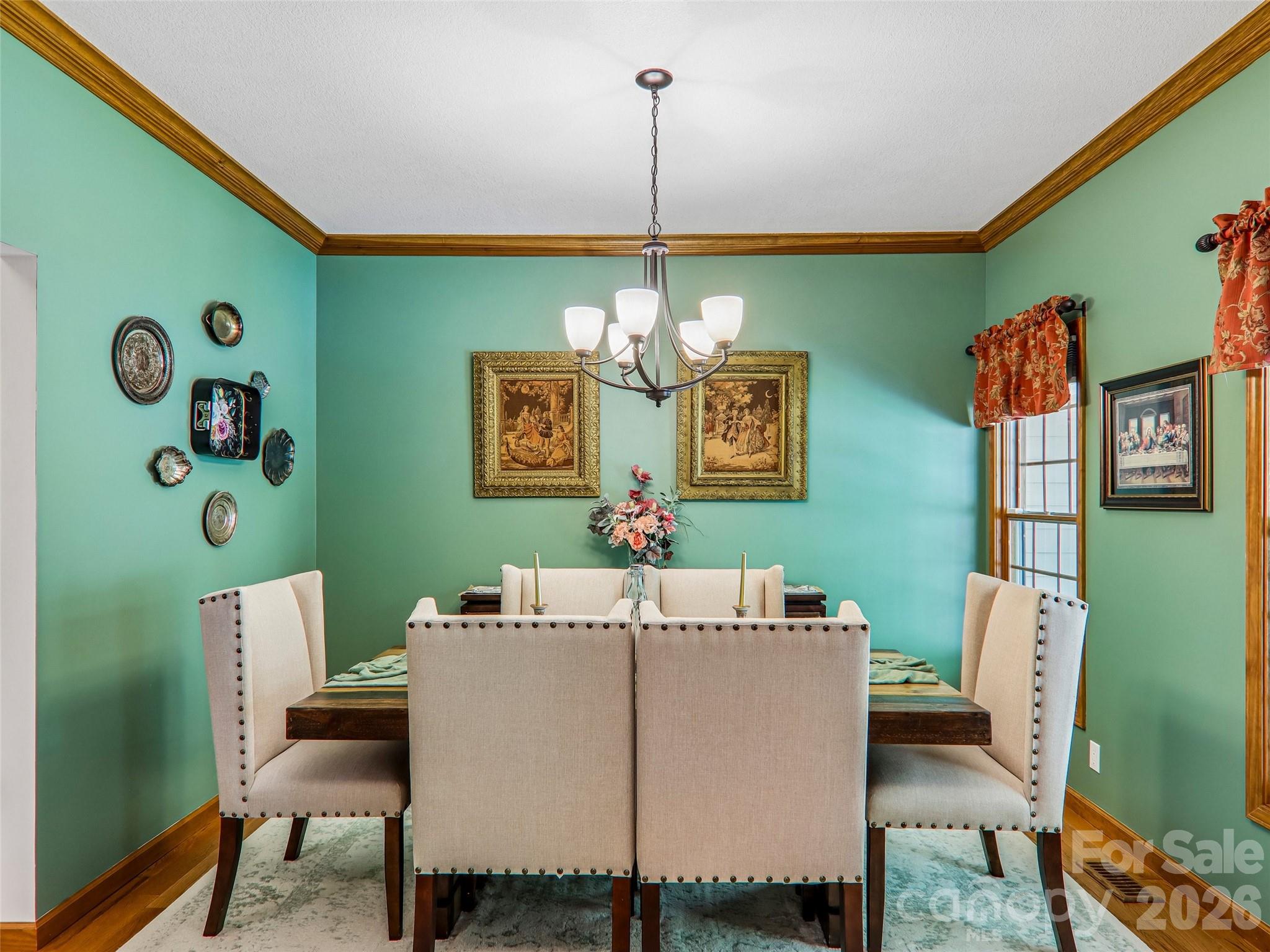 Semi-open dining room, Chandelier and crown molding elevate the dining experience. - 16 Hobe Crest, Hendersonville