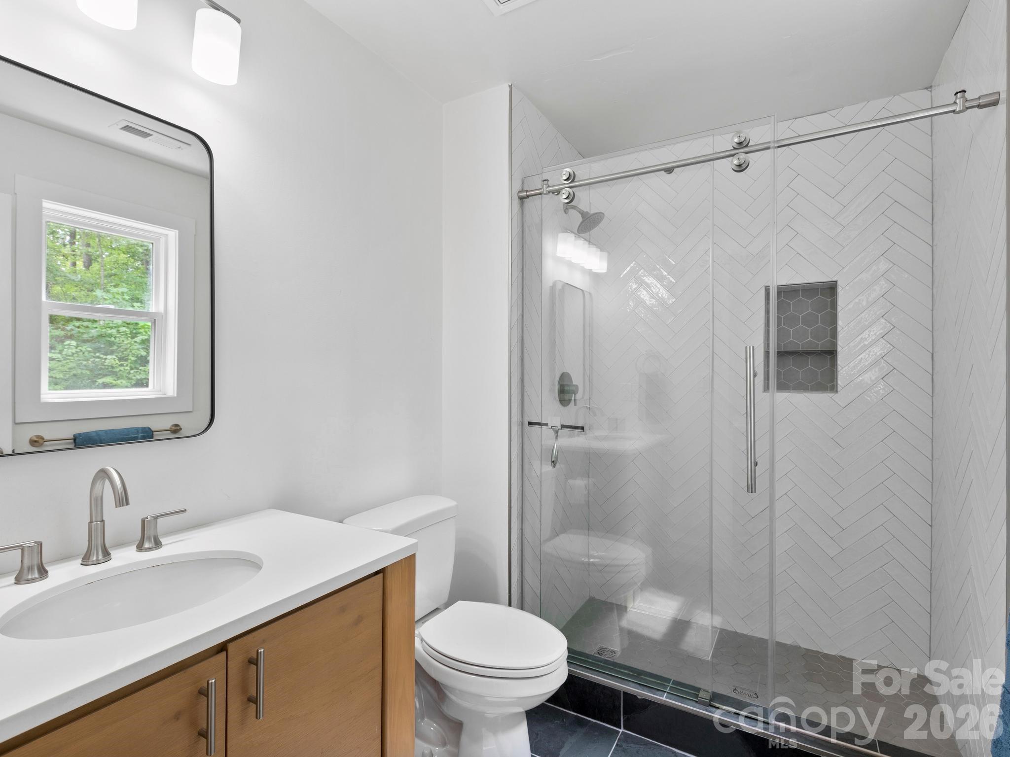 Fully tiled shower + contemporary finishes in primary en suite. - 41 Bear Trail, Fairview