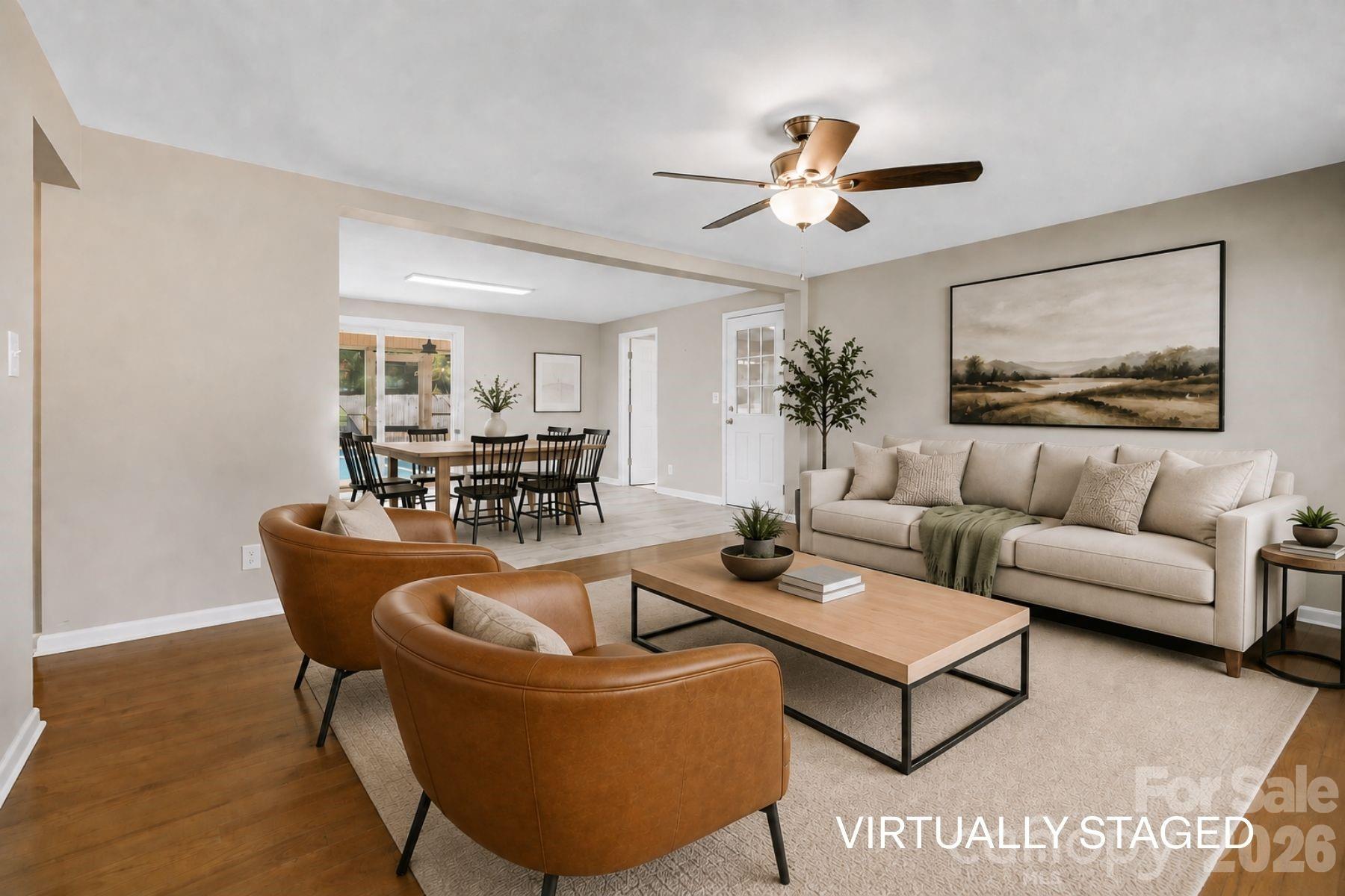 Living room opens to dining room. (virutally staged) - 409 Oak Street Extension, Forest City
