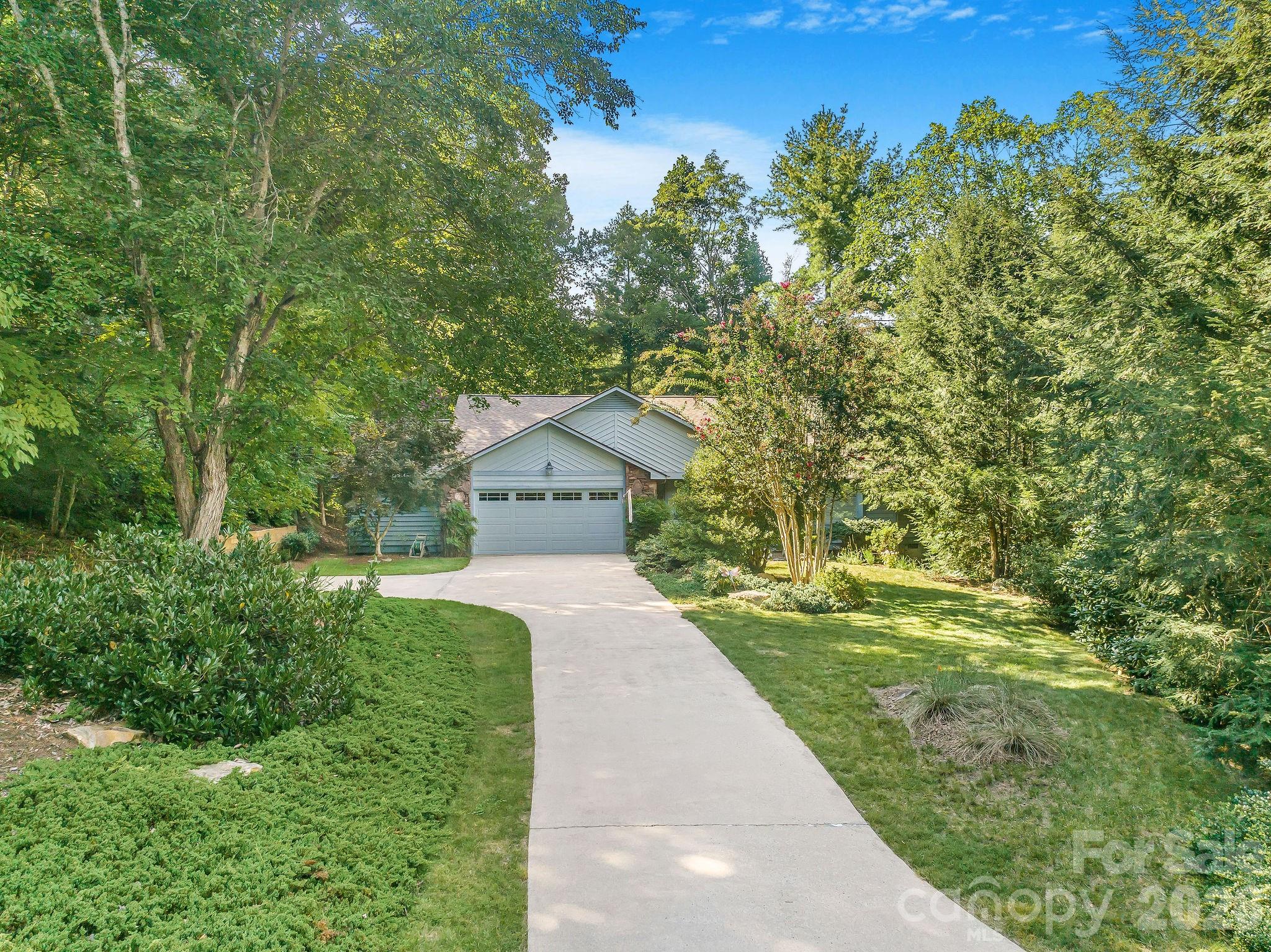 The home sits back from Hillcreek Drive and the approach features mature landscaping with a variety of color and texture. - 31 Hillcreek Drive, Asheville