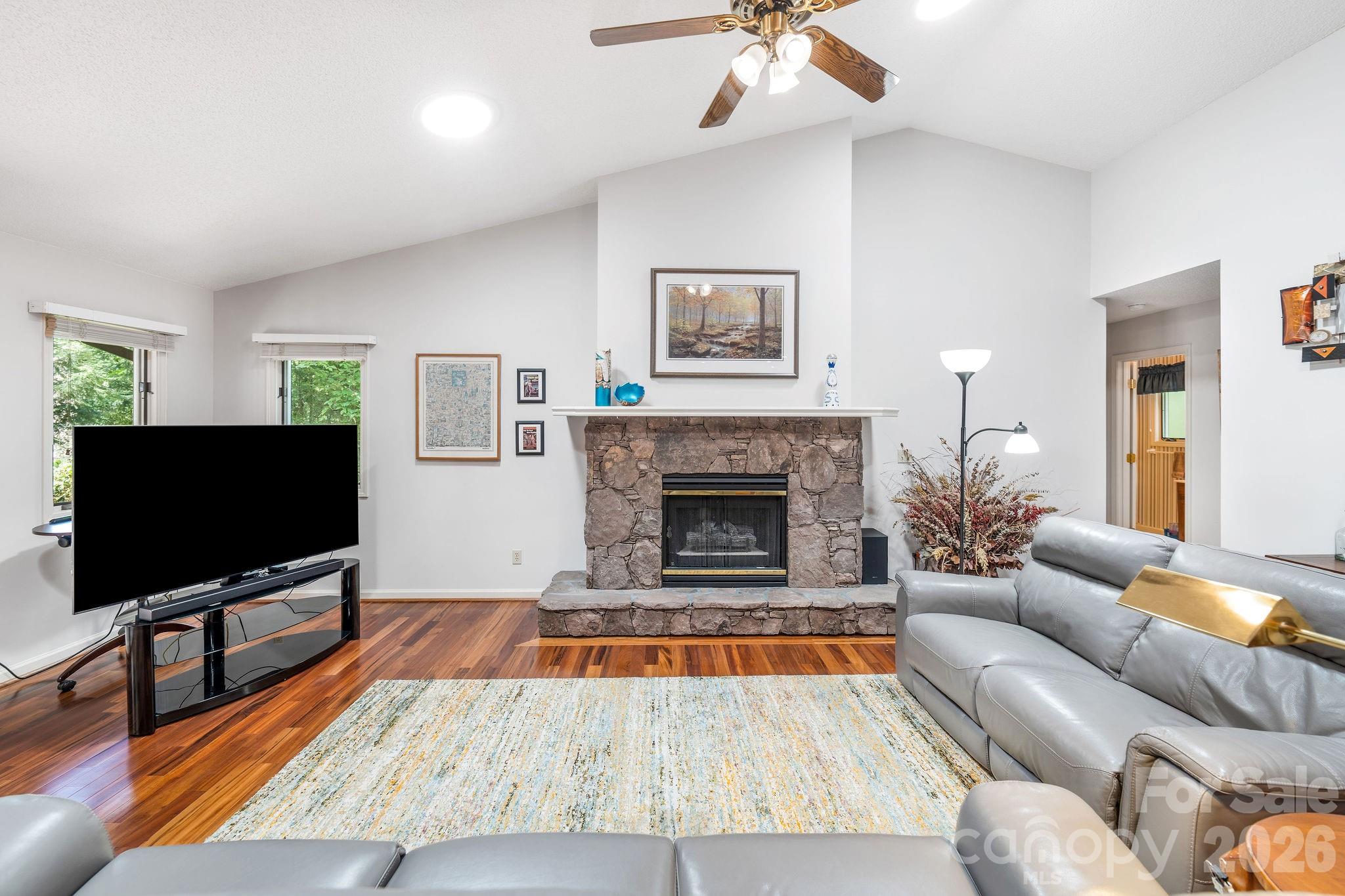 The stone fire place anchors as the focal point of the living room. - 31 Hillcreek Drive, Asheville