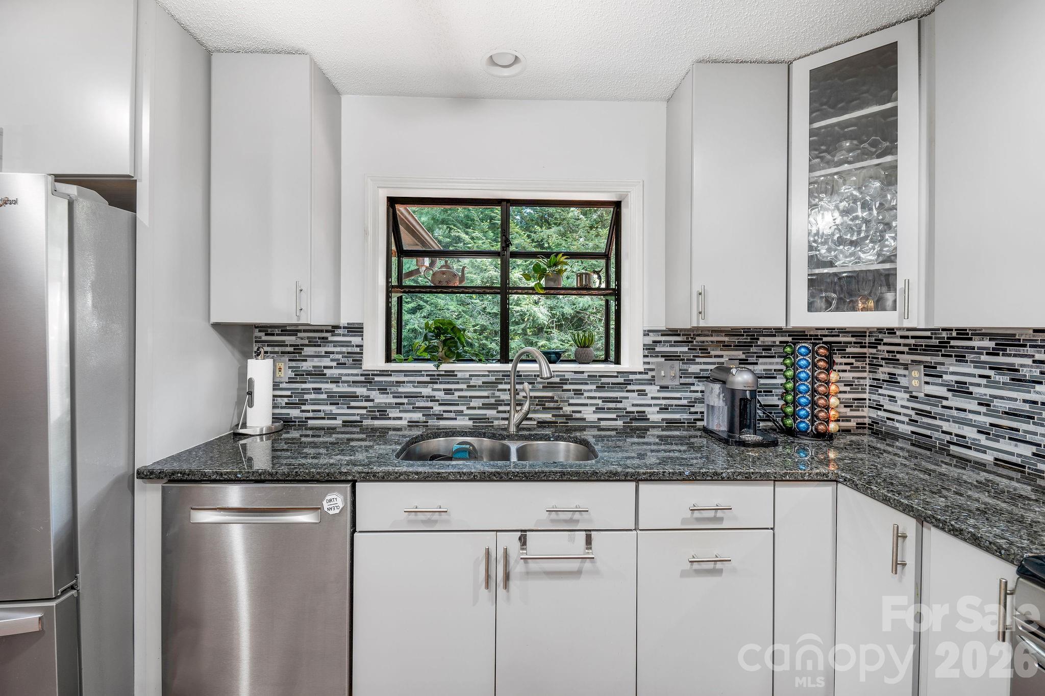 There is a greenhouse window above the kitchen sink. - 31 Hillcreek Drive, Asheville